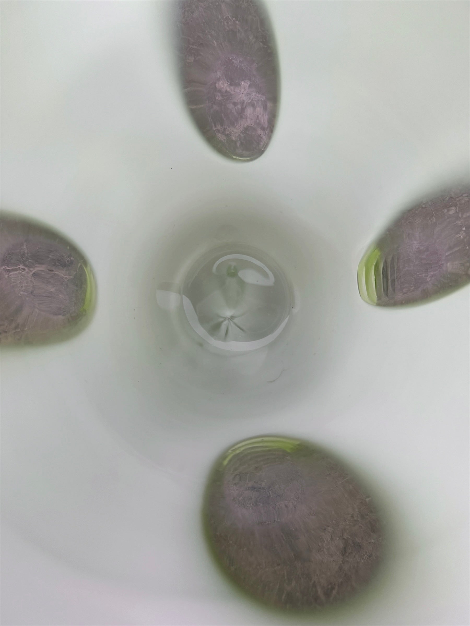 A mid-century modern, lime green cased-glass vase with a wide, flared rim and a thick, clear glass base. The exterior is a glossy chartreuse green, while the interior is lined with solid milk-white glass. The defining feature is a large, vertical oval cutout window that pierces directly through the center of the vase's body, creating an open-air negative space.