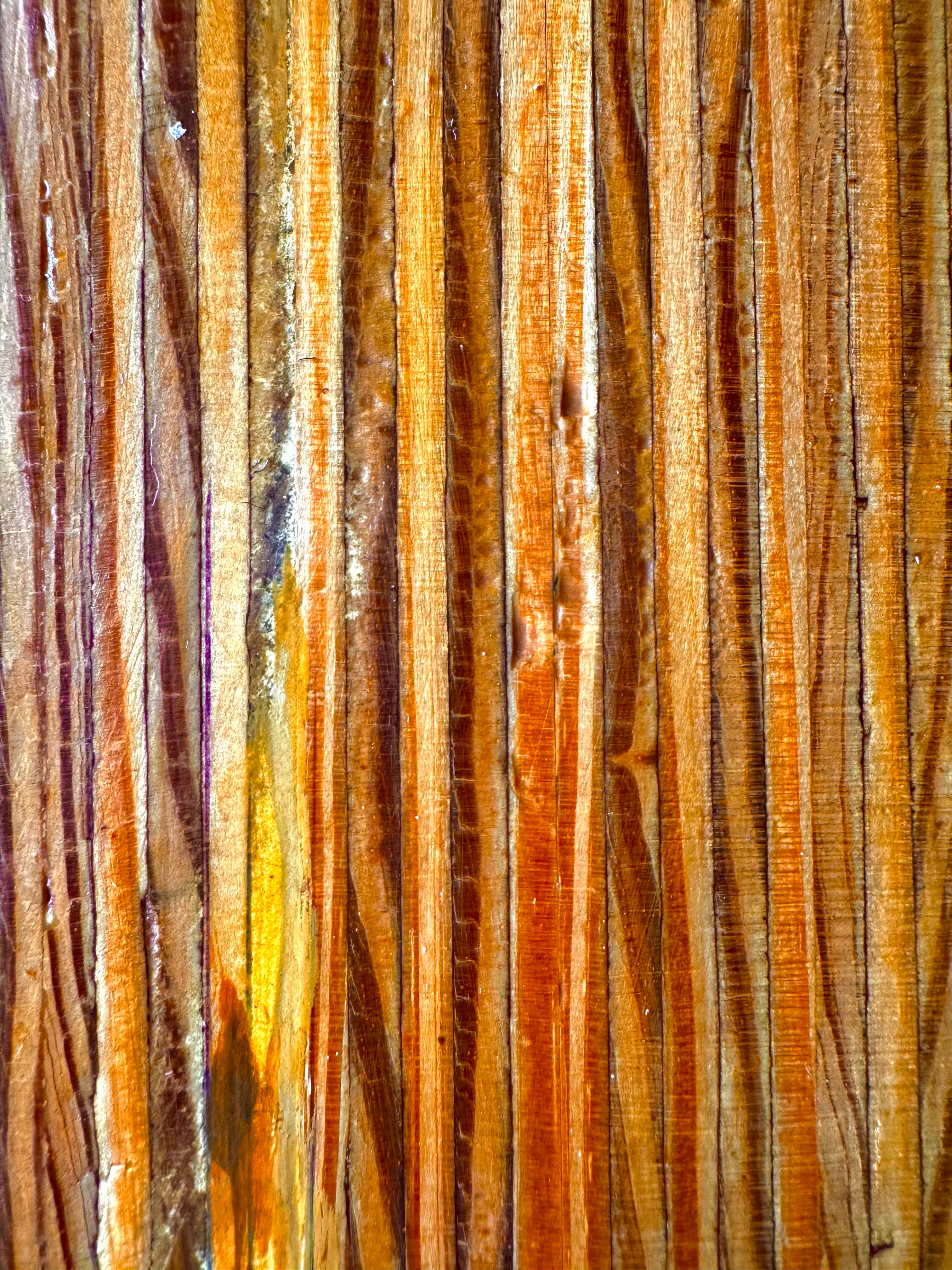 A wooden sculpture featuring a dark square base, a vertical trunk that branches into two angled supports, and a turned wooden sphere resting on the higher support.