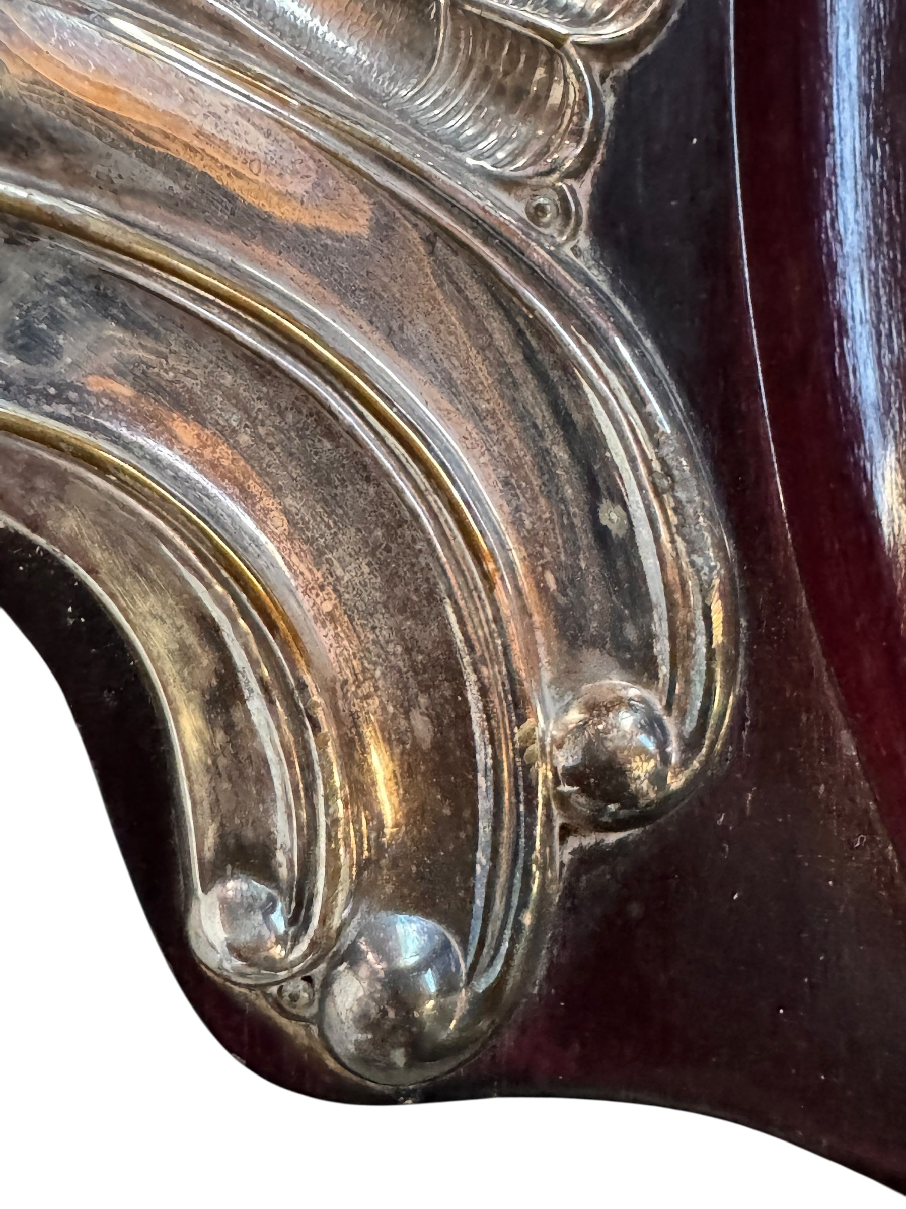 An ornate Art Deco serving tray featuring a highly figured burlwood center and silver-plated handles and rim