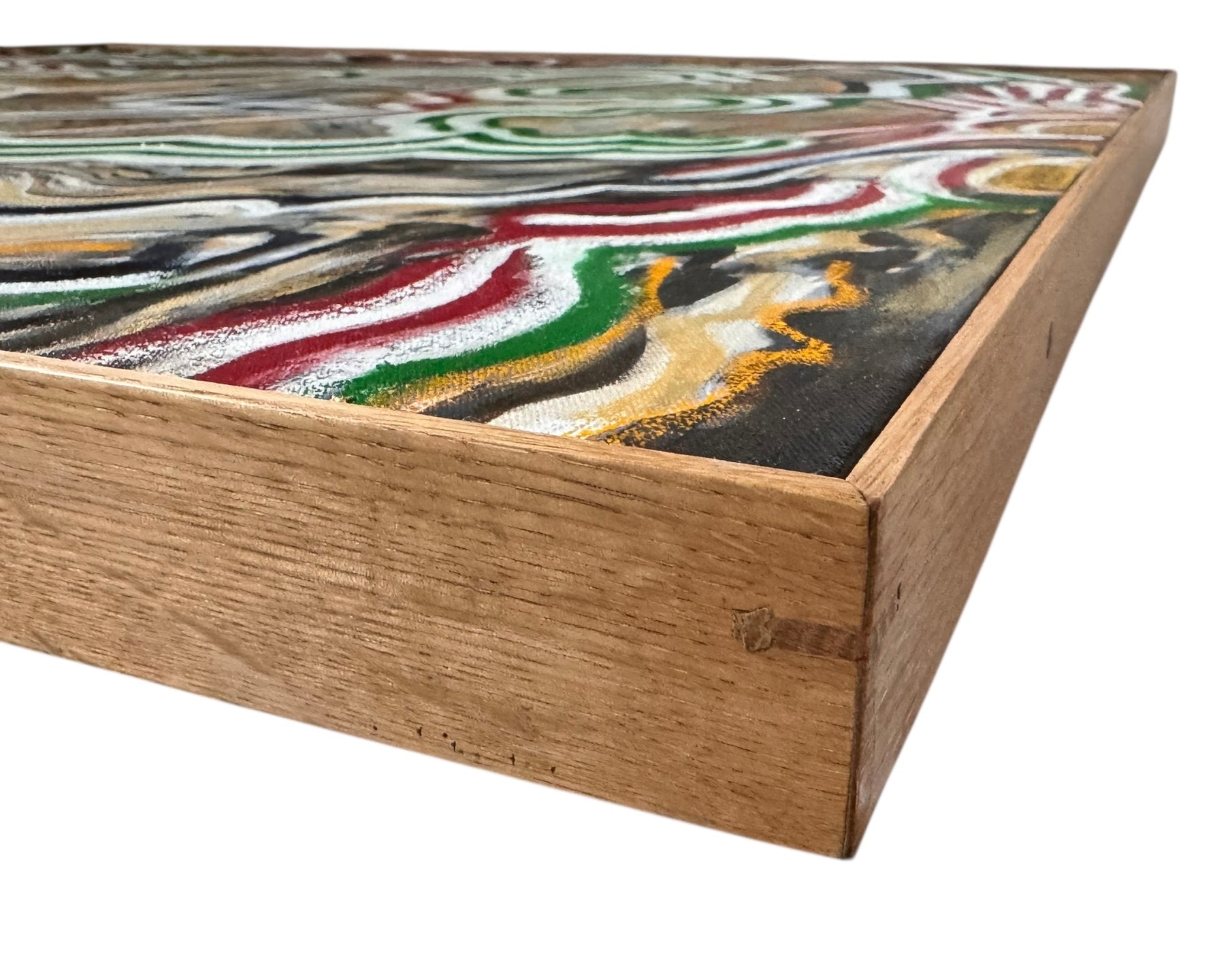 A close-up, angled view of an abstract oil painting titled 'Topography' by Robert Wymer. The painting's edge reveals thick, textured swirls of brown, gold, red, green, and white paint. It is framed in a natural light-brown teak wood frame, with a visible corner joint where two pieces of wood meet