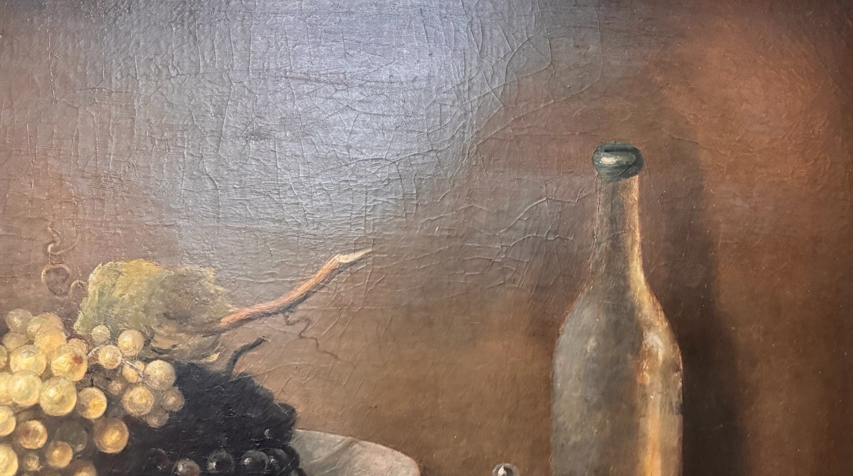 Oil painting, 'Still Life with Fruit and Cheese' by Michel Rivol, 1887. Features grapes, melons, cheese under a glass dome, and a bottle on a tablecloth against a dark background