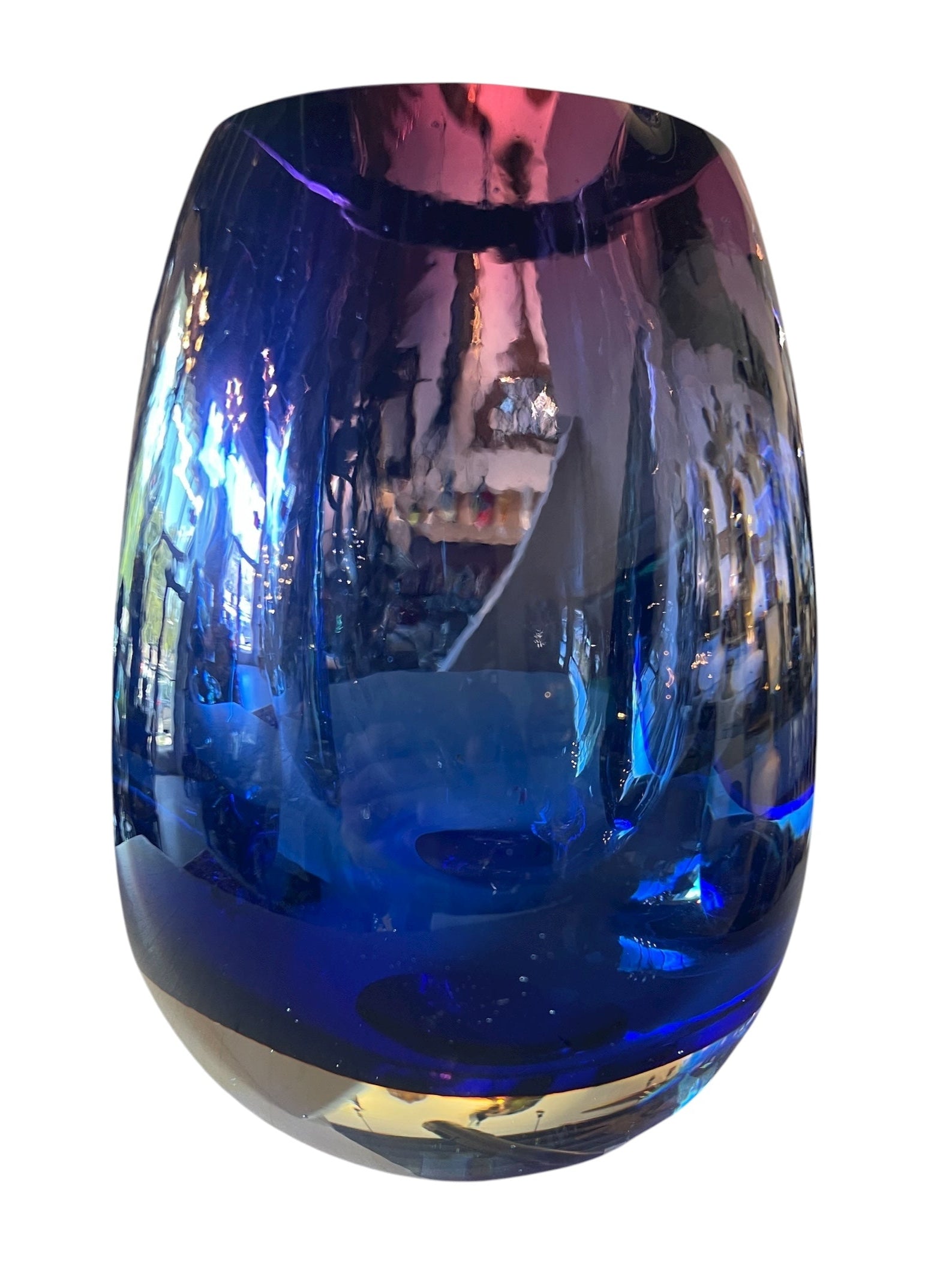 Sommerso glass vase with flattened sides creating a fish-eye effect, featuring cobalt and indigo colors and internal bubbles.