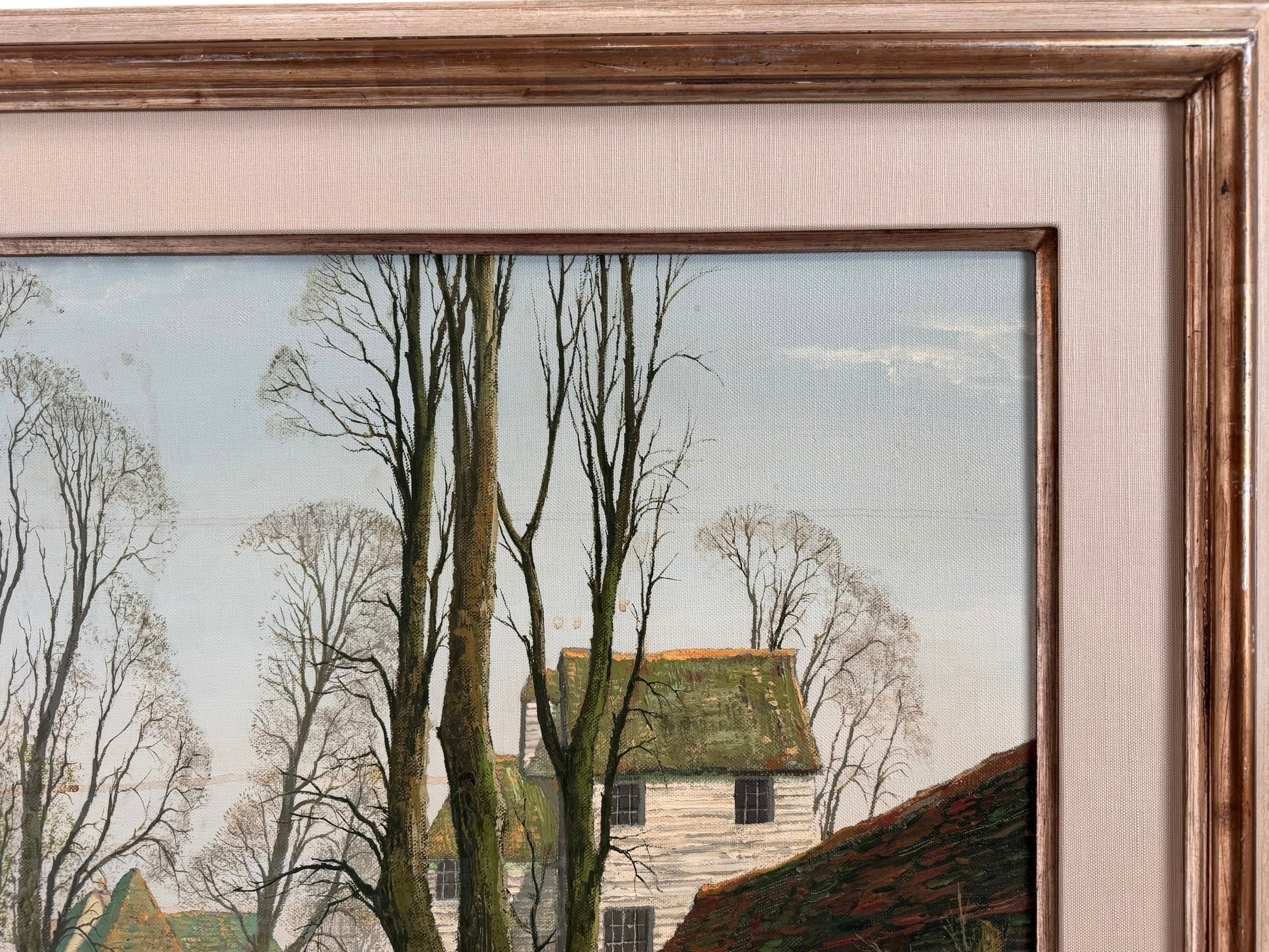 A naturalistic landscape oil painting by Michael Reilly titled "Mill Pond with Bridge" depicts a small town scene with a stone bridge over a mill pond, several buildings, and numerous bare trees under a grey sky