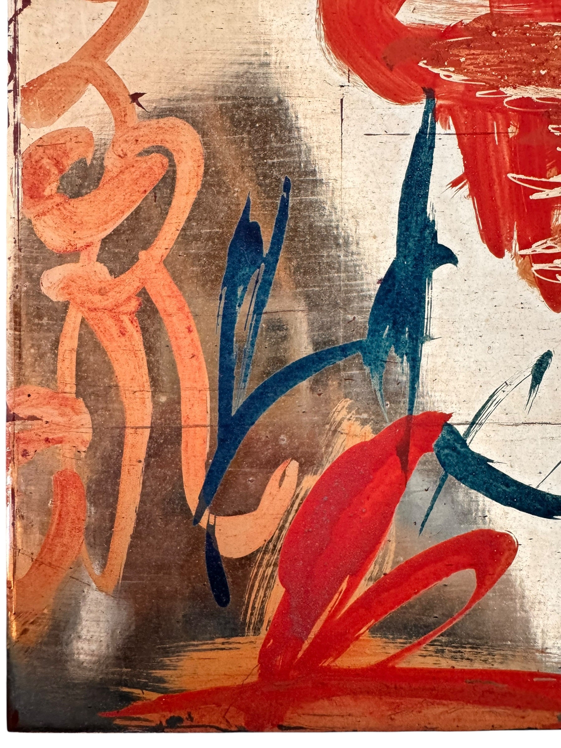 A vertical composition on a bright, reflective metallic background (likely silver or light gold leaf). The piece is defined by sparse, high-energy gestures: a sweeping arc of orange and red at the top, a central cluster of textured red paint, and a scattering of teal-blue "C" shapes and hooks. The metallic surface is highly visible, giving the piece a luminous, modern feel.
