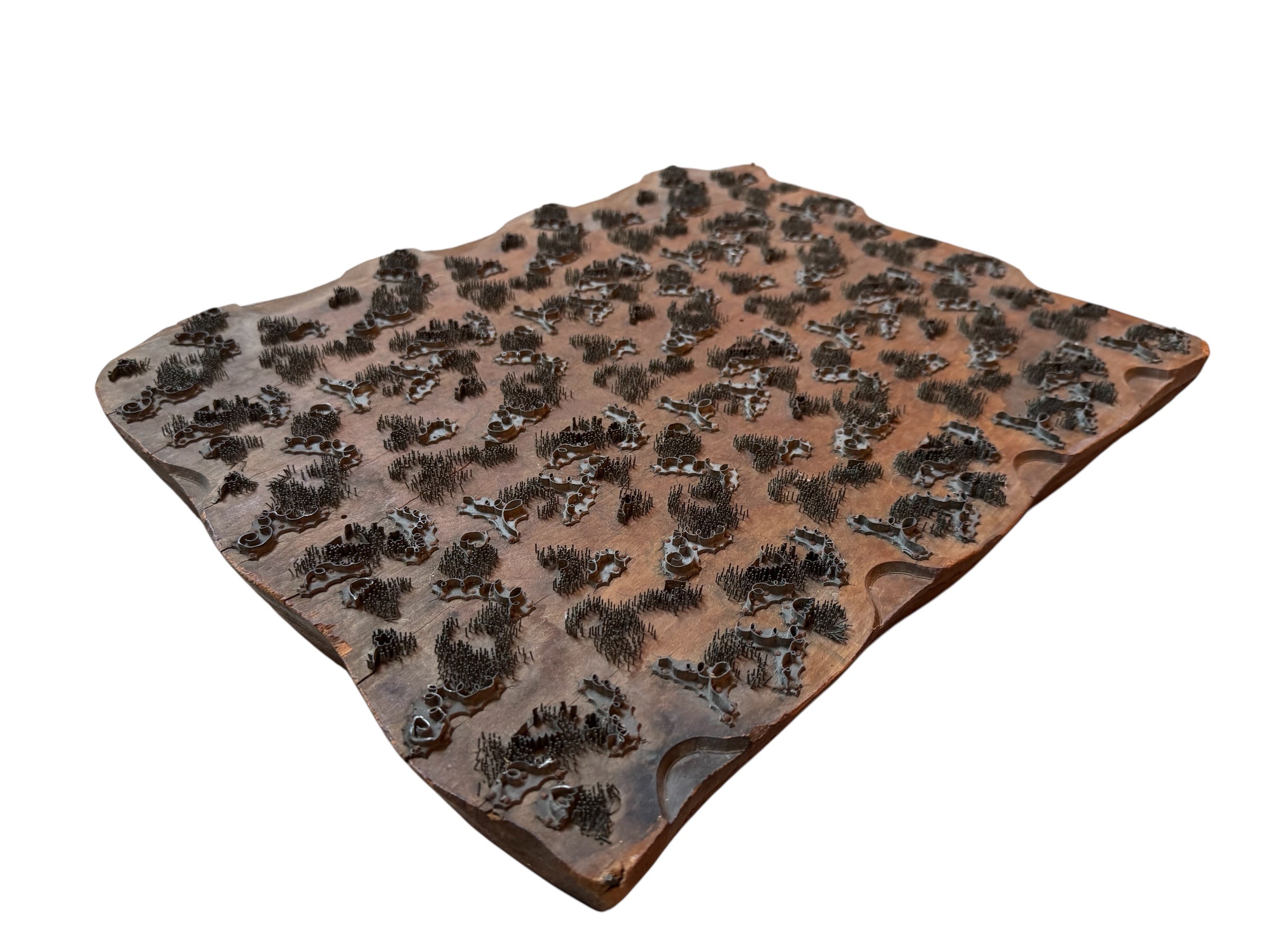 A vintage carved wooden printing block with intricate, repeating patterns, engraved with an unknown artist's signature and stamped "Made in France." The wood shows signs of age and wear, adding to its historical character