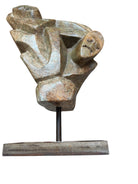 Figural sculpture in the Shona style, Zimbabwe. Two abstracted figures are intertwined, carved from greenish-brown soapstone. Sculpture rests on a dark iron stand.