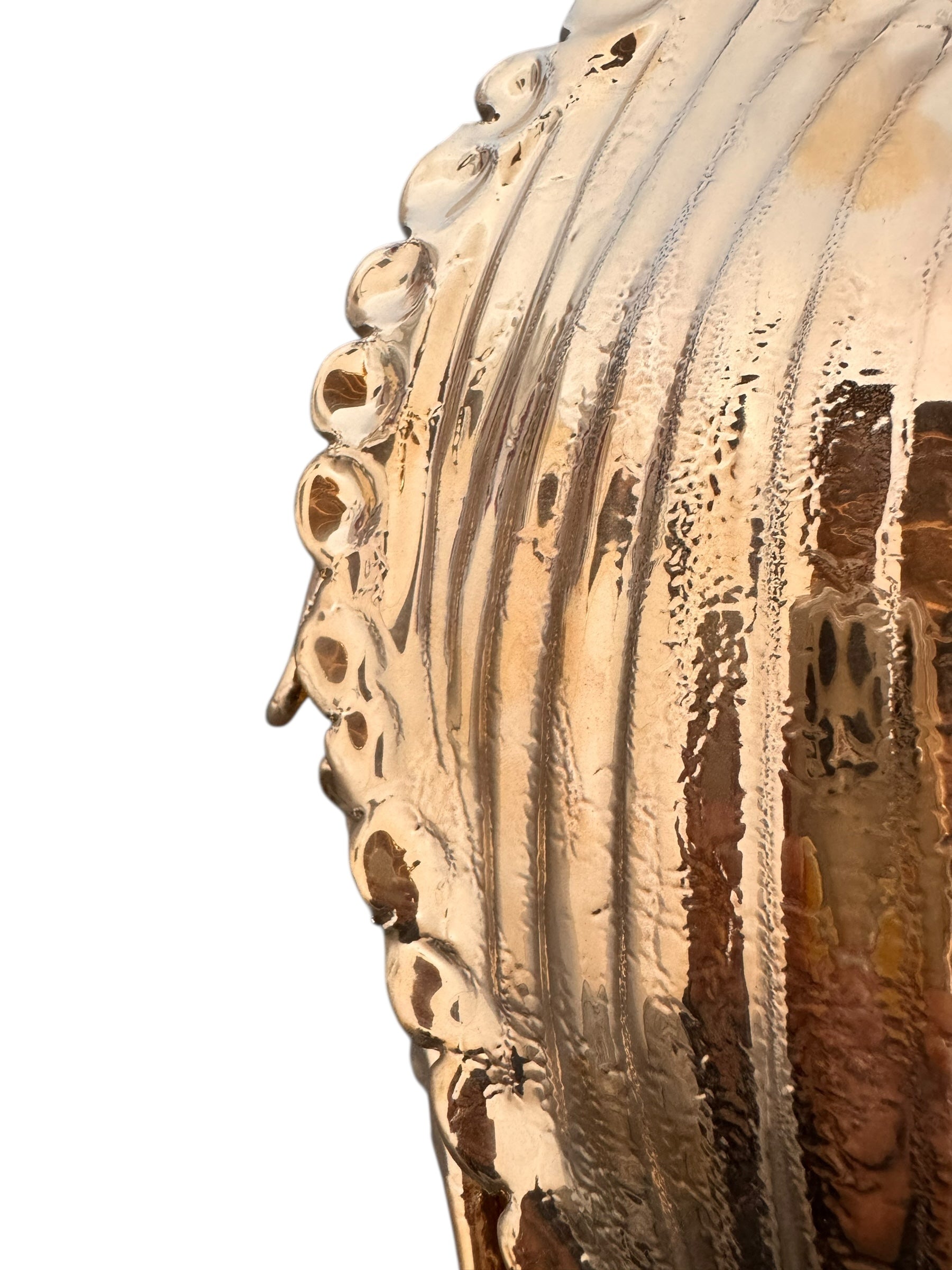 A handcrafted ceramic sculpture of a rhinoceros beetle by Enza Fasano, featuring a brilliant, high-gloss gold metallic finish. The beetle is captured in a dynamic, slightly upturned pose with detailed textures on its ribbed shell and prominent, curved horns. The piece reflects light across its polished surface, showcasing the artist’s signature fusion of traditional Pugliese pottery and contemporary luxury.