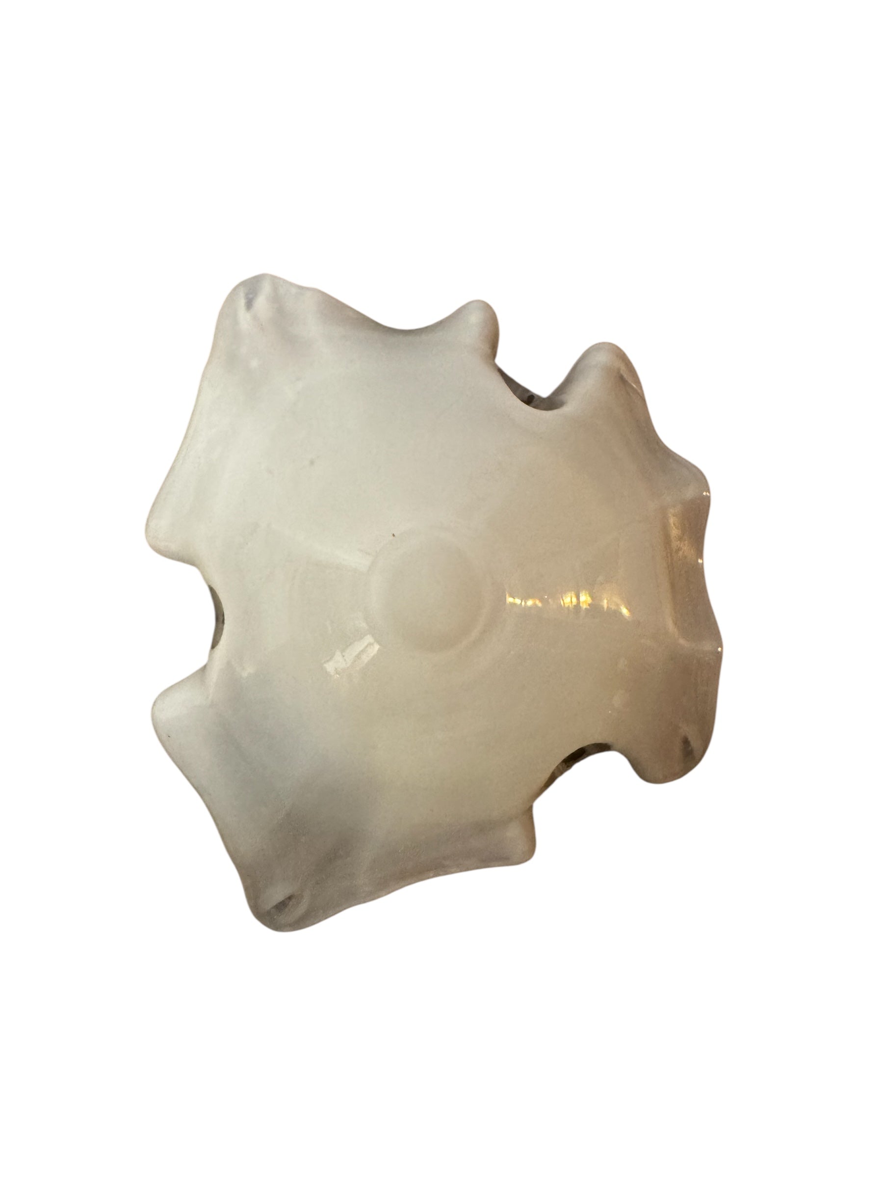 A Murano art glass bowl with a freeform shape, featuring layered swirls of brown, orange, and cream, accented with gold flecks. The bowl has a translucent white base.