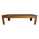 A 1970s wooden coffee table with a cork top and glass cover, featuring a rectangular shape with rounded edges.