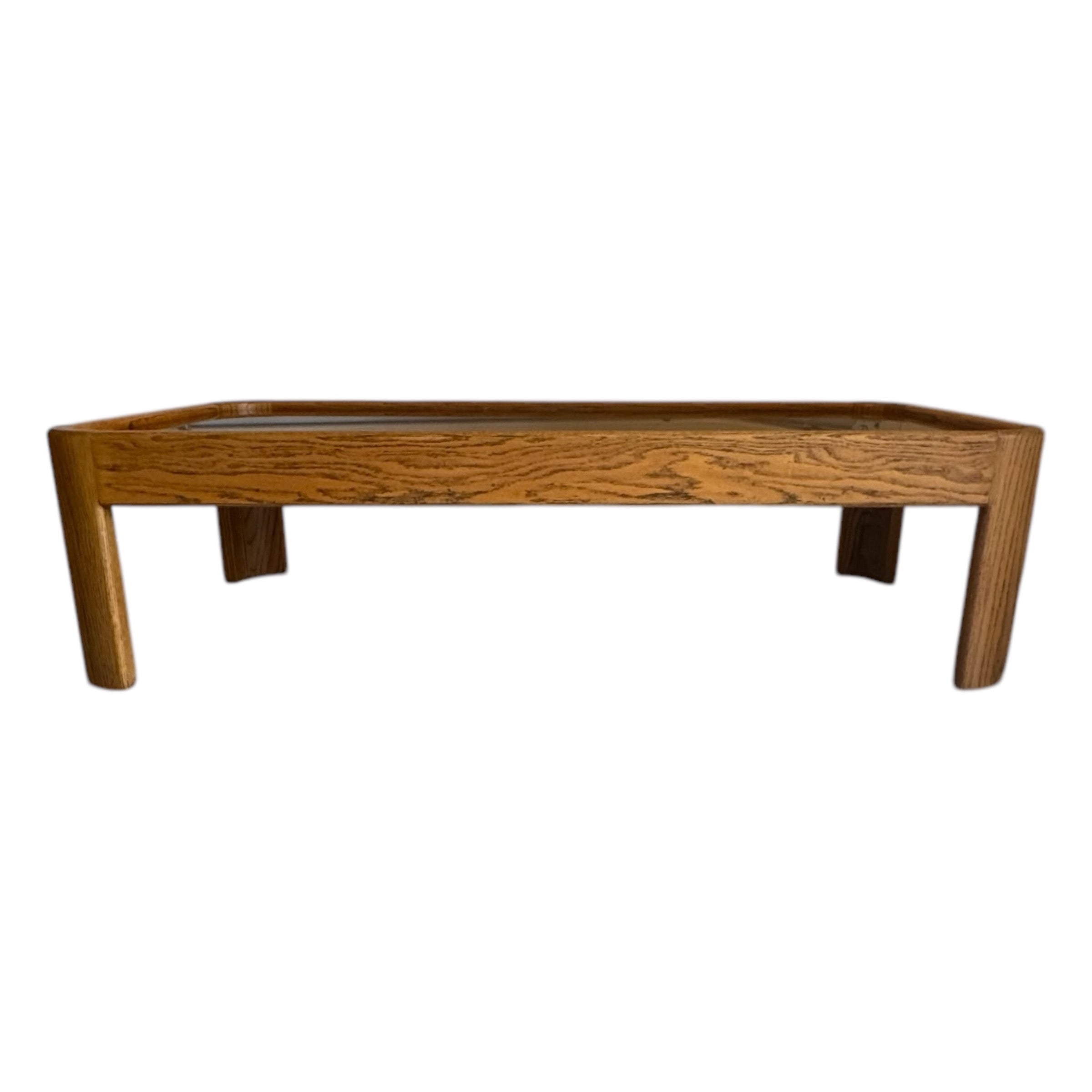 A 1970s wooden coffee table with a cork top and glass cover, featuring a rectangular shape with rounded edges.