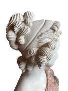 A 25-inch high polychrome marble bust of a woman, featuring white marble for her face and hair, with a base and draped fabric adorned with carved roses and leaves.