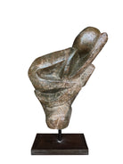 Figural sculpture in the Shona style, Zimbabwe. Two abstracted figures are intertwined, carved from greenish-brown soapstone. Sculpture rests on a dark iron stand.