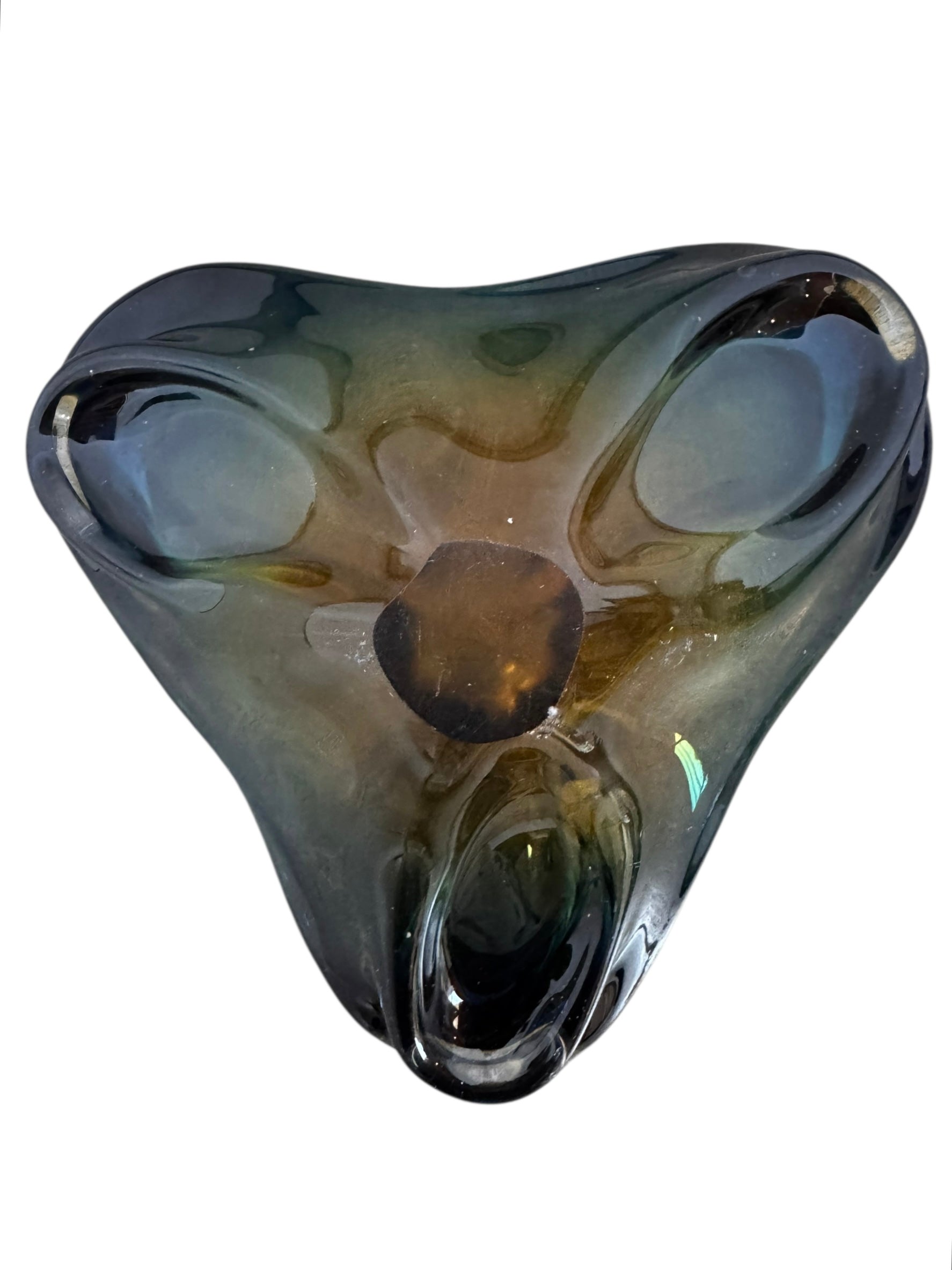 A vintage, hand-blown art glass bowl with a wavy, organic shape and a blue and amber/yellow swirl design