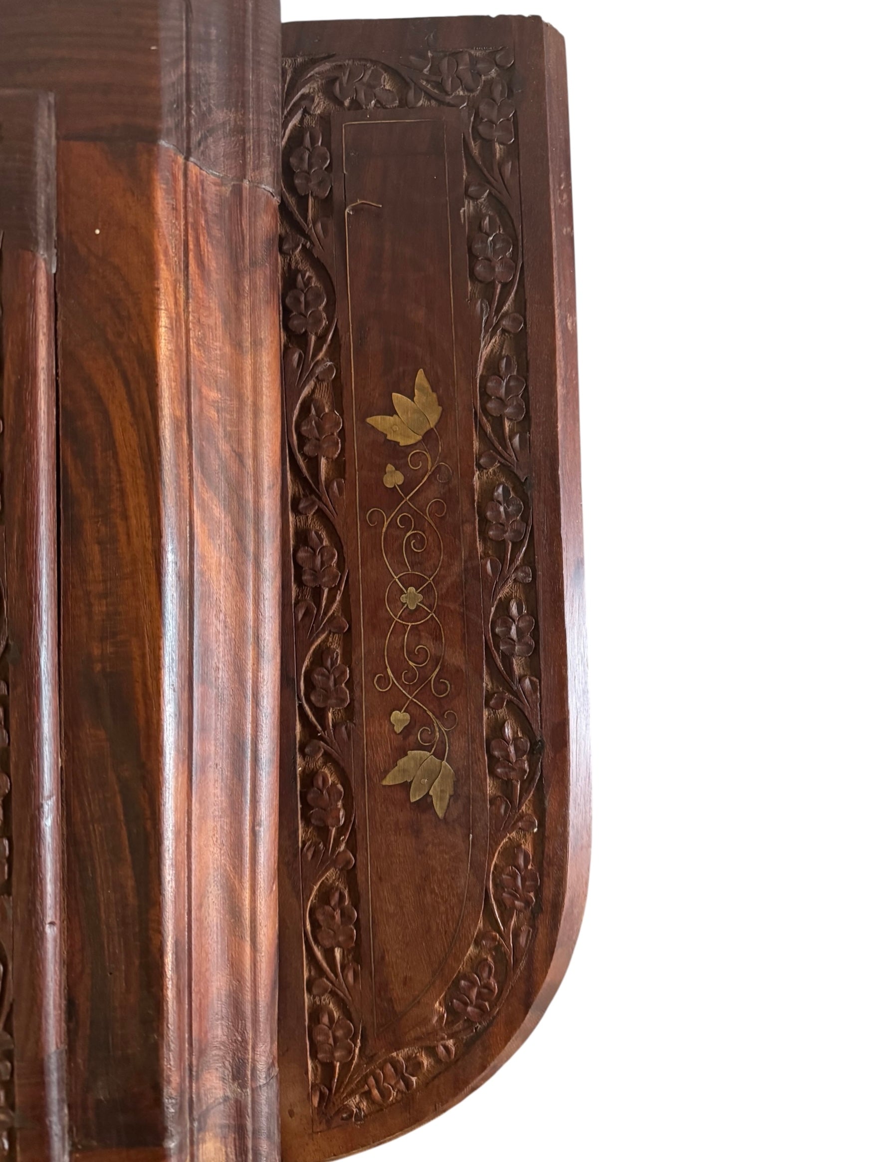 Antique bar cabinet with wood inlay and brass floral details, open to reveal interior shelving and bar storage