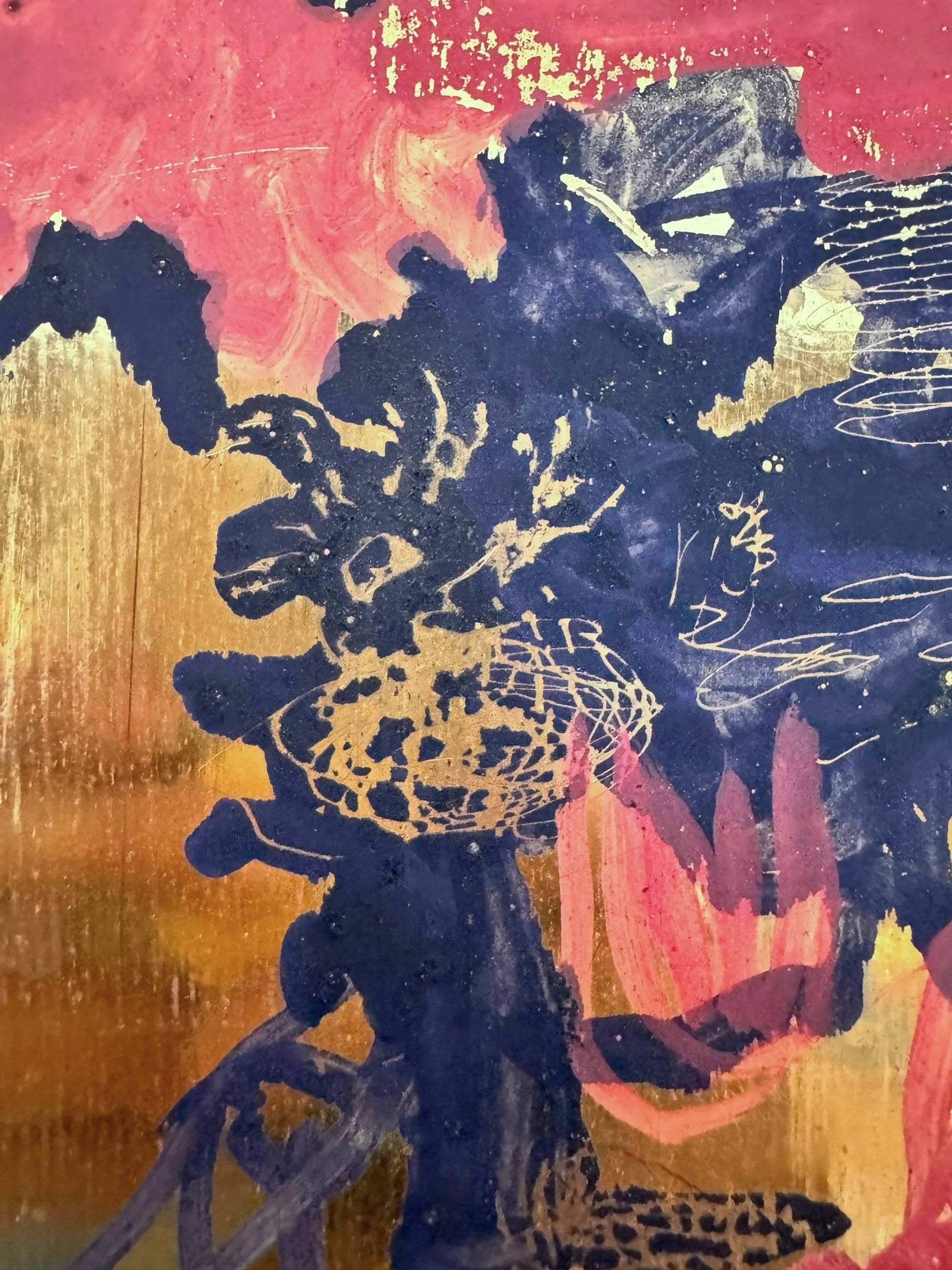 A vibrant abstract painting on a metallic gold-toned panel characterized by dense, energetic layering. The palette is dominated by saturated pinks, deep blacks, and earthy oranges.
In the upper half, horizontal strokes of orange and pink suggest a sunset or landscape, while the lower half features heavy, gestural applications of black paint that anchor the composition. Fine, white or silver linear scribbles are scratched into or layered over the pigment, adding a sense of frantic movement.