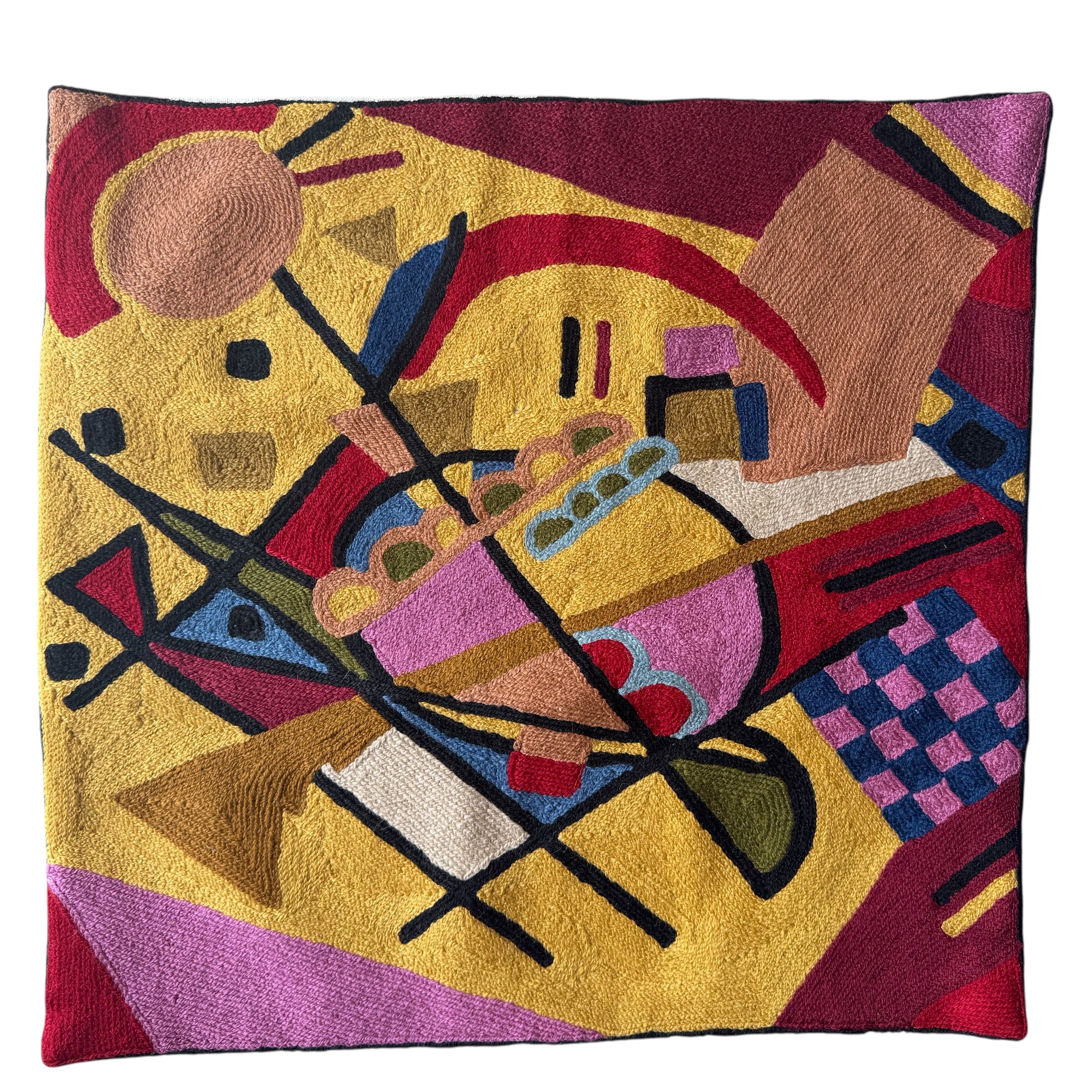 colorful abstract.Vibrant cross-stitched pillows from India with various artistic designs, sourced in Aix-en-Provence.