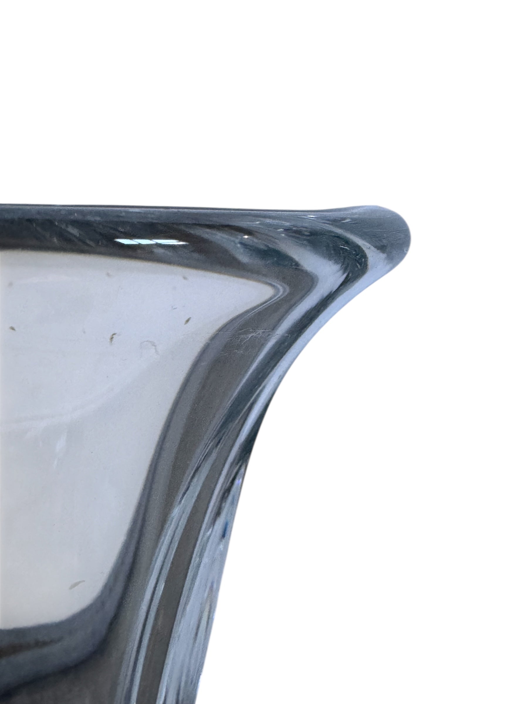 A clear crystal vase with a flared opening and a twisted, sculptural base.
The provided image is of a vintage Vannes Le Châtel crystal vase, which is a piece of French art glass