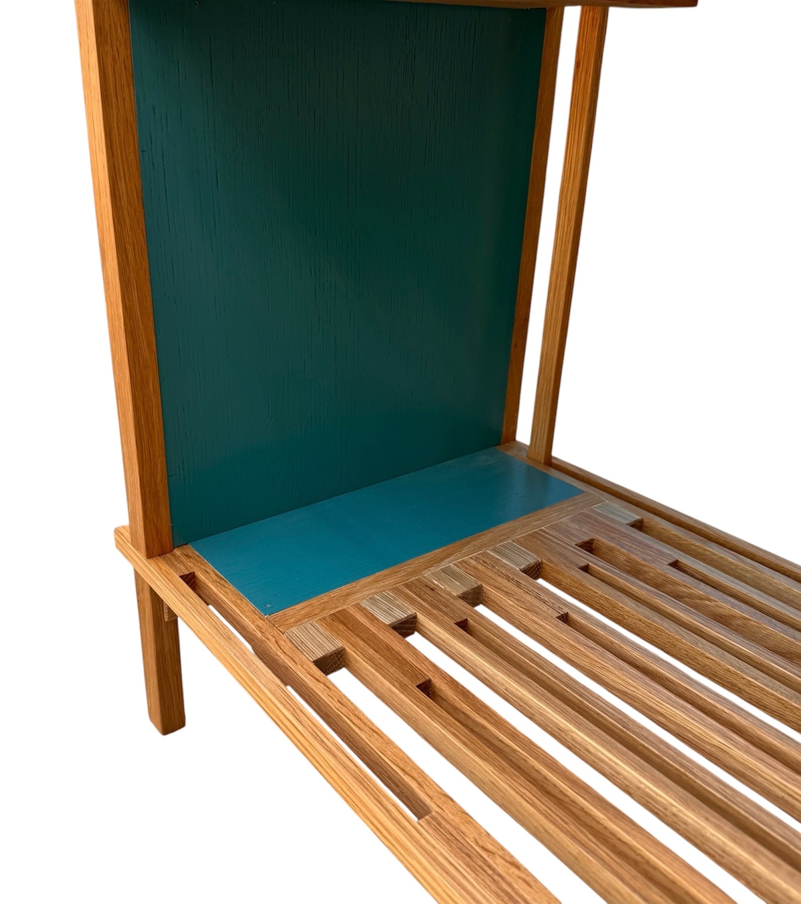 A three-tiered wooden shelving unit featuring a mix of light oak and teal-colored panels. The piece has an open, structural design with visible joinery, vertical supports that extend past the top shelf, and a horizontal backrest at the top. The middle and bottom shelves feature slatted wood center sections flanked by solid teal panels, while the top surface is primarily solid wood with teal accents at the edges.
