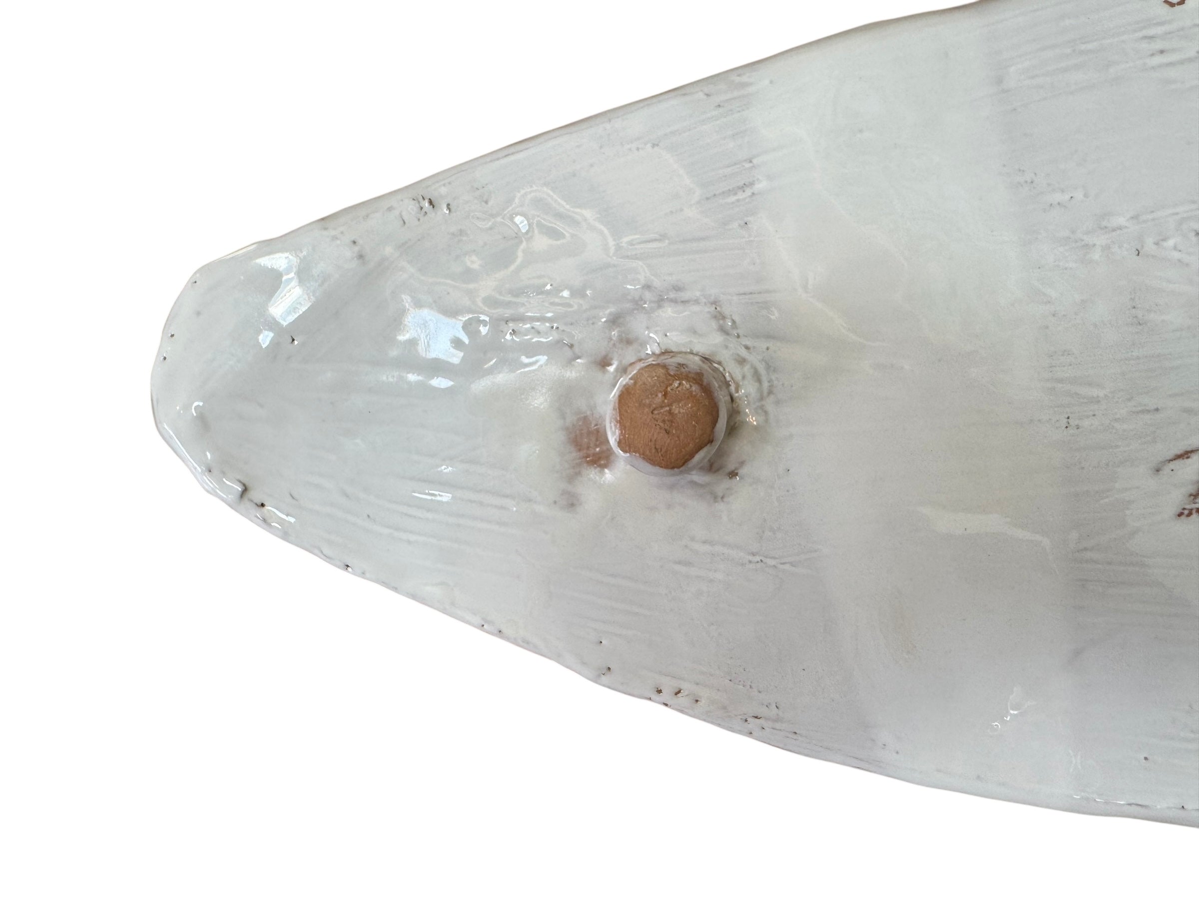 A white, glazed ceramic platter in the shape of a prickly pear cactus pad with attached prickly pear fruit. The surface has raised dots representing spines.