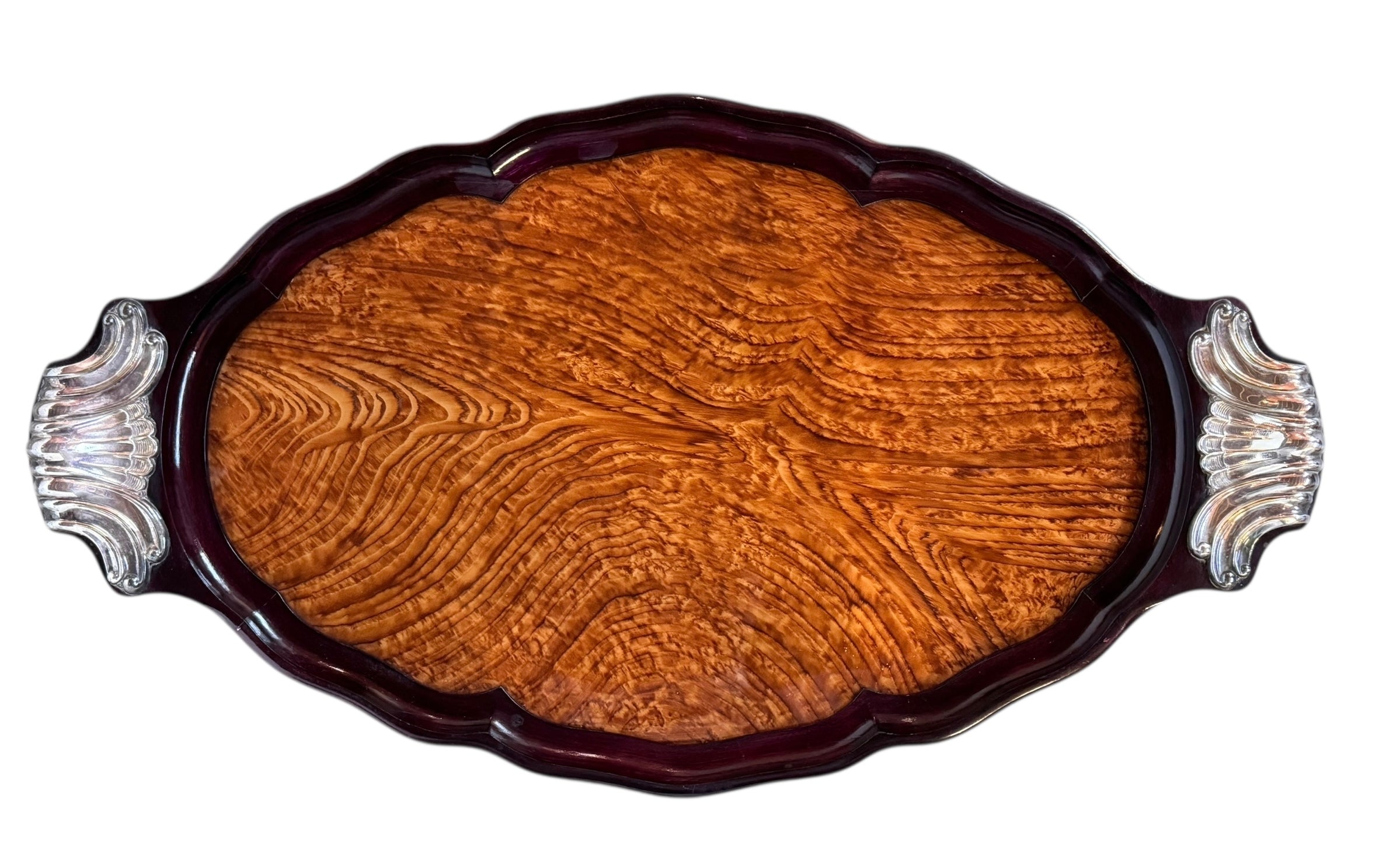 An ornate Art Deco serving tray featuring a highly figured burlwood center and silver-plated handles and rim