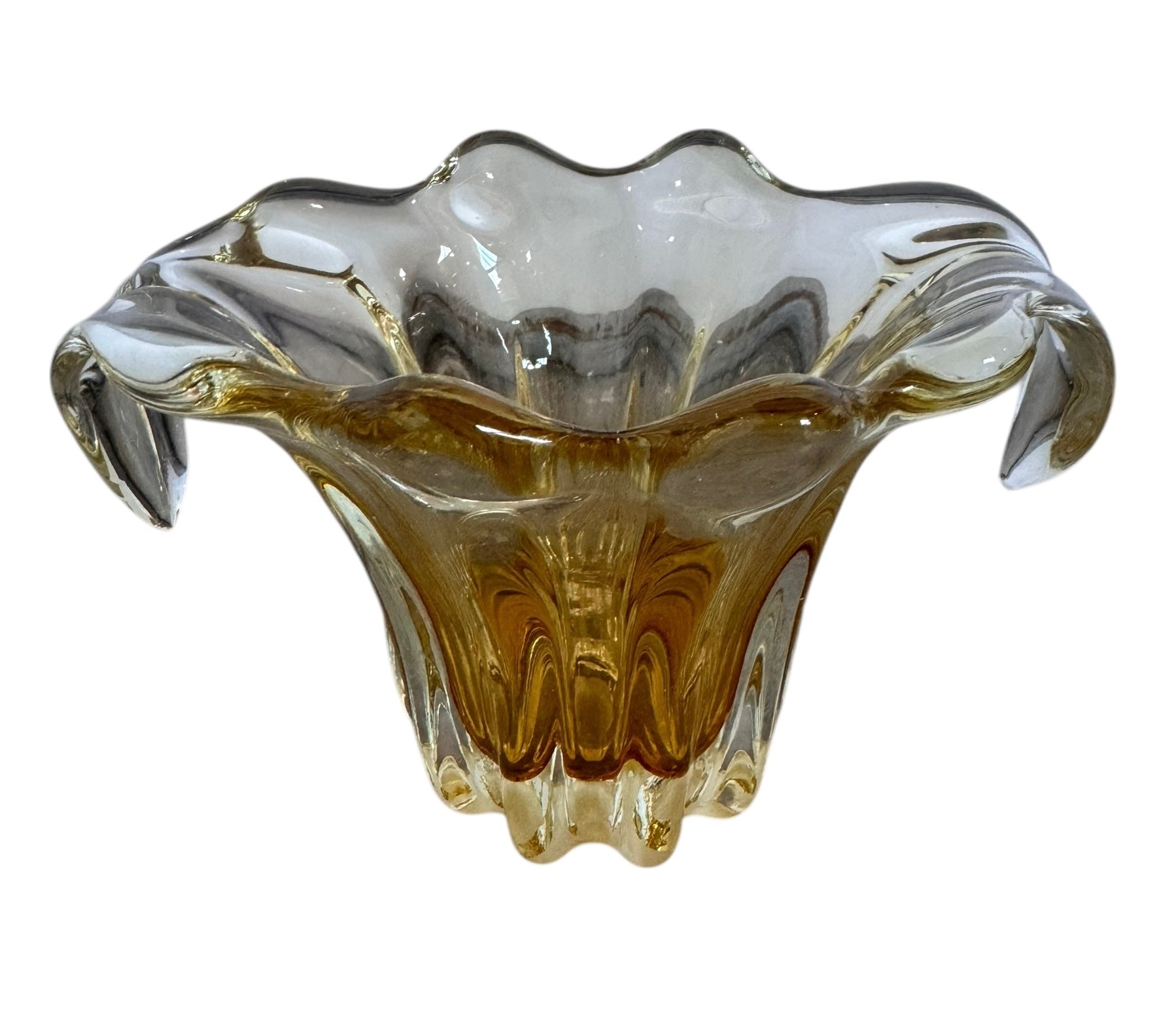 A hand-blown art glass vase with a scalloped, tulip-shaped rim, featuring an amber-to-clear color gradient and a ribbed base
