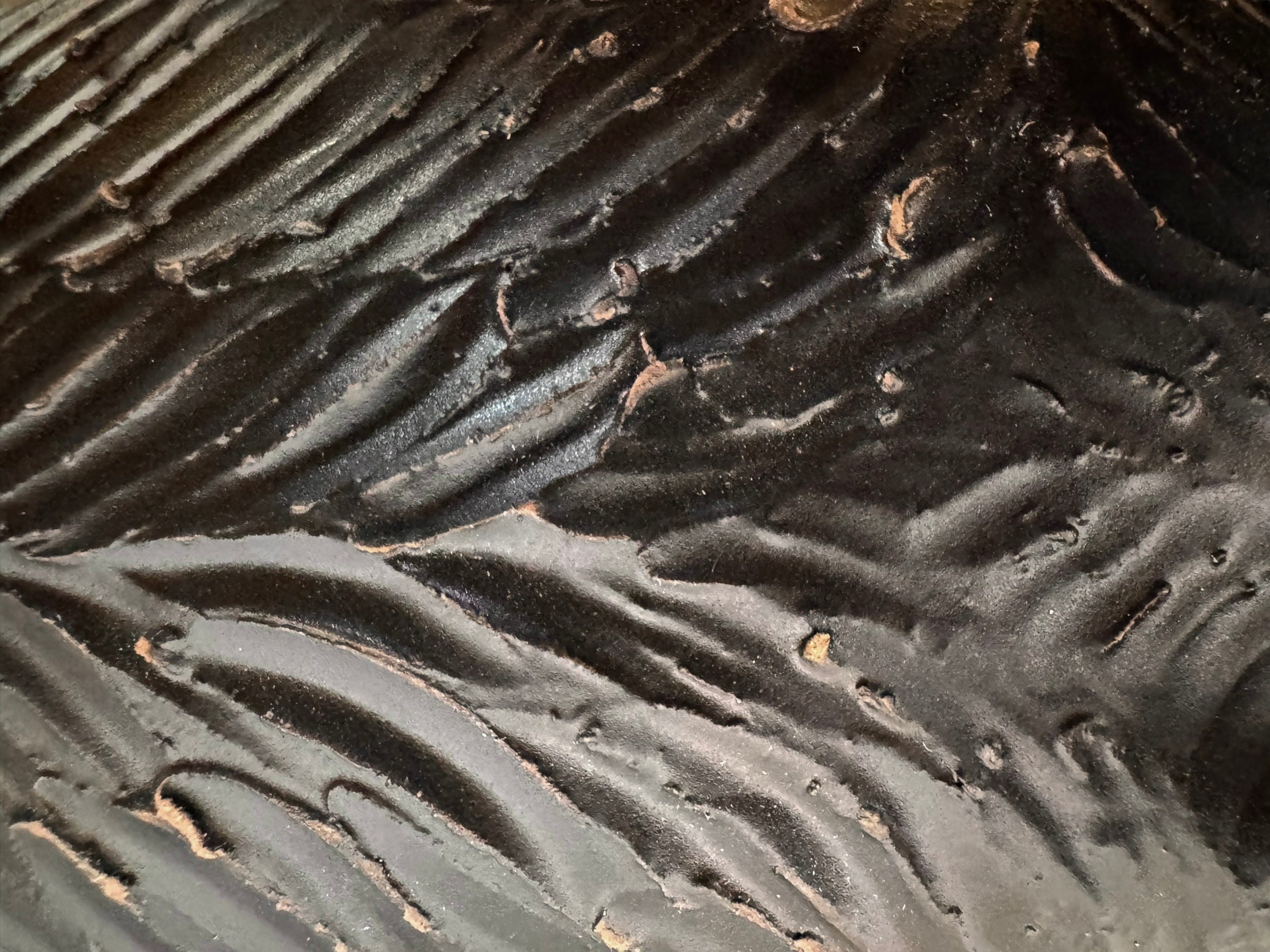 A dark, chocolate-brown ceramic sculpture by Enza Fasano depicting the stylized head of a hunting dog, such as a pointer or hound. The piece features a smooth, elongated snout and large, floppy ears with a textured, feathery finish that contrasts with the sleek crown of the head. The minimalist design emphasizes the dog's elegant profile and long neck.