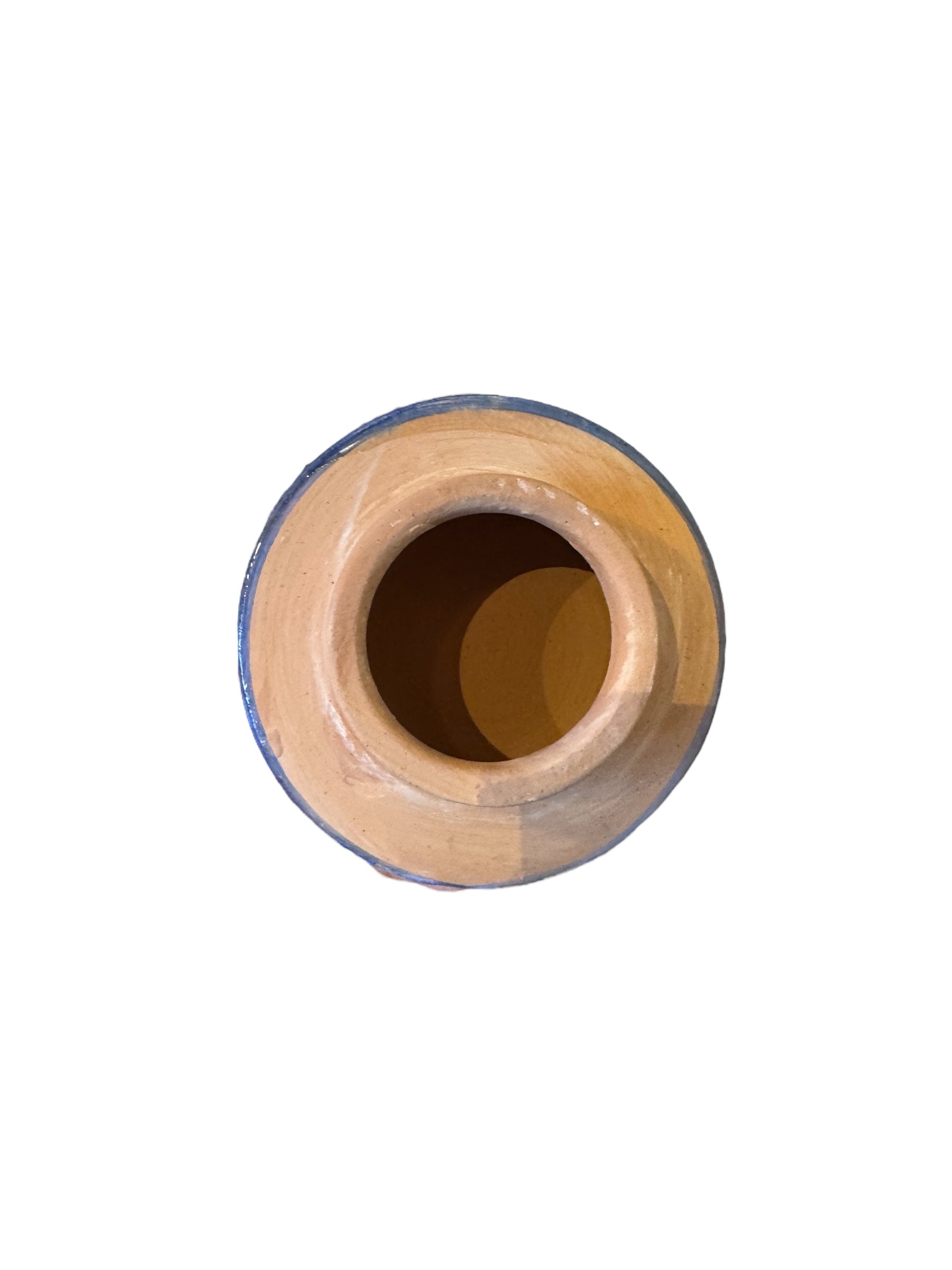 Close-up of a ceramic foot sculpture by Domenico Pinto. The foot is decorated with intricate hand-painted designs inspired by Apulian folklore and accented with 24KT gold. A stylized gilt mask sits atop the foot.