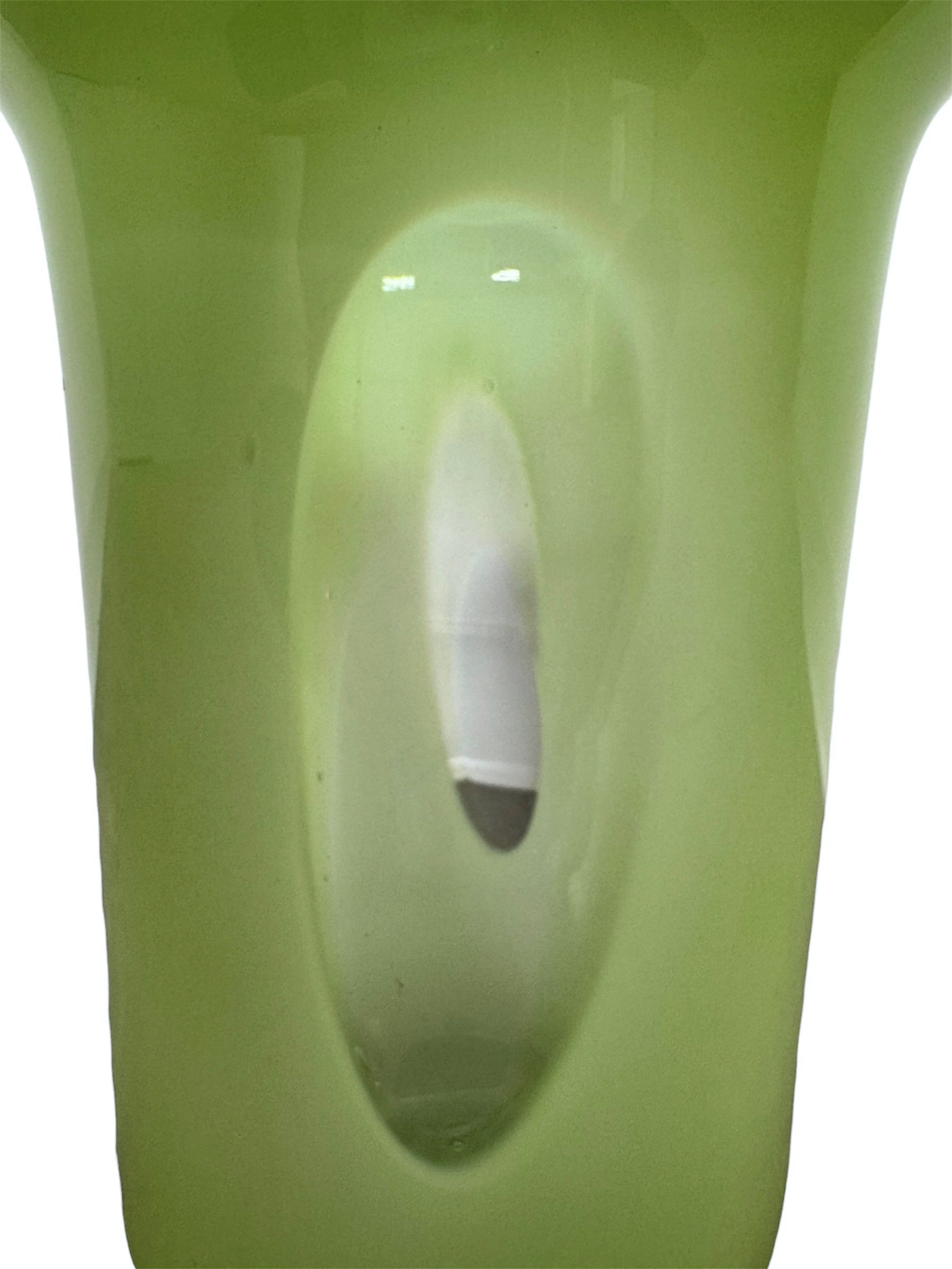 A mid-century modern, lime green cased-glass vase with a wide, flared rim and a thick, clear glass base. The exterior is a glossy chartreuse green, while the interior is lined with solid milk-white glass. The defining feature is a large, vertical oval cutout window that pierces directly through the center of the vase's body, creating an open-air negative space.