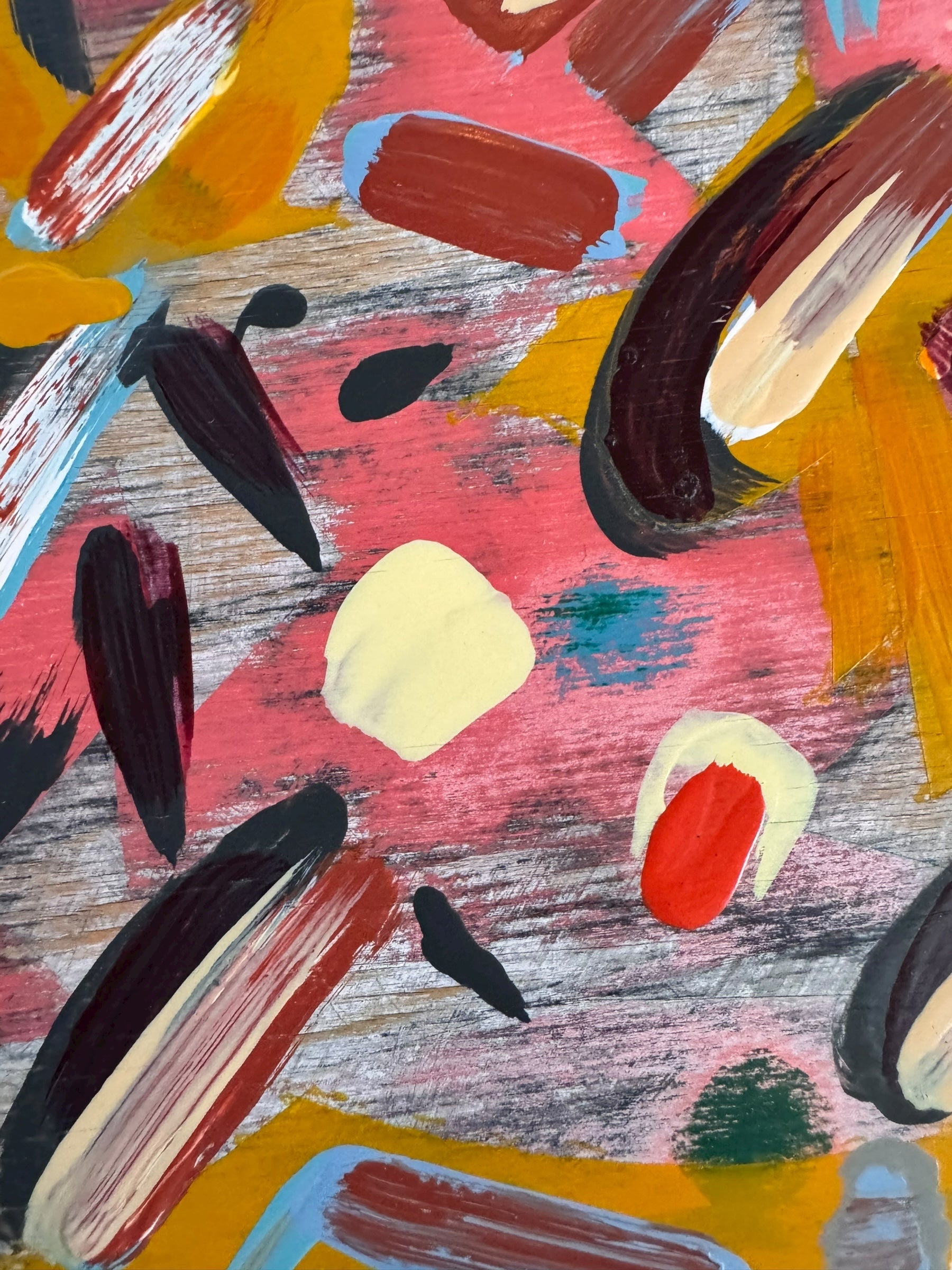 An abstract painting titled 'Cascade of Gold and Pink' by Robert Wymer, framed in dark wood. The artwork features a vibrant pink background densely covered with a dynamic arrangement of multi-directional, oblong, and dash-like brushstrokes in gold, red, blue, gray, white, and black.