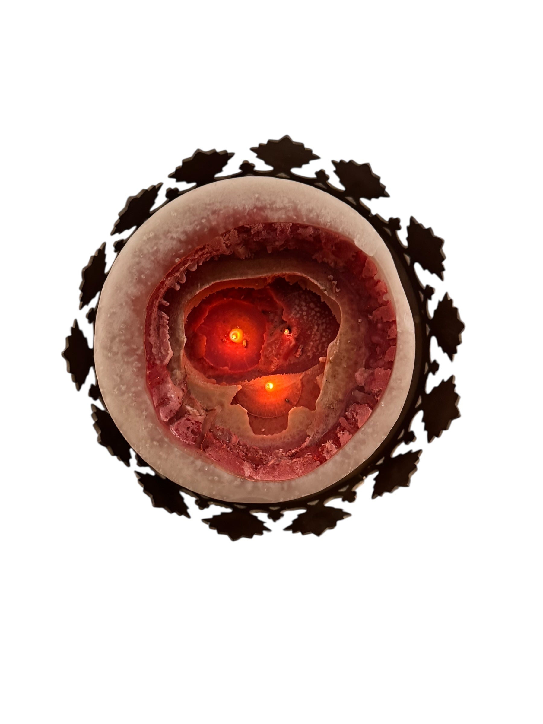 A tall, ornate, antique brass or bronze Gothic church candlestick holder with a pink candle in the top.