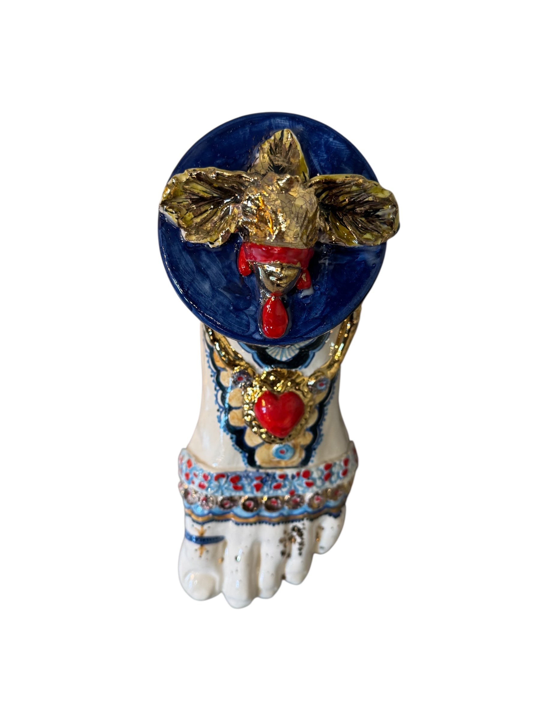 Ceramic foot sculpture by Domenico Pinto featuring hand-painted details, gold accents, a sacred heart, and an angel figure with a blindfold