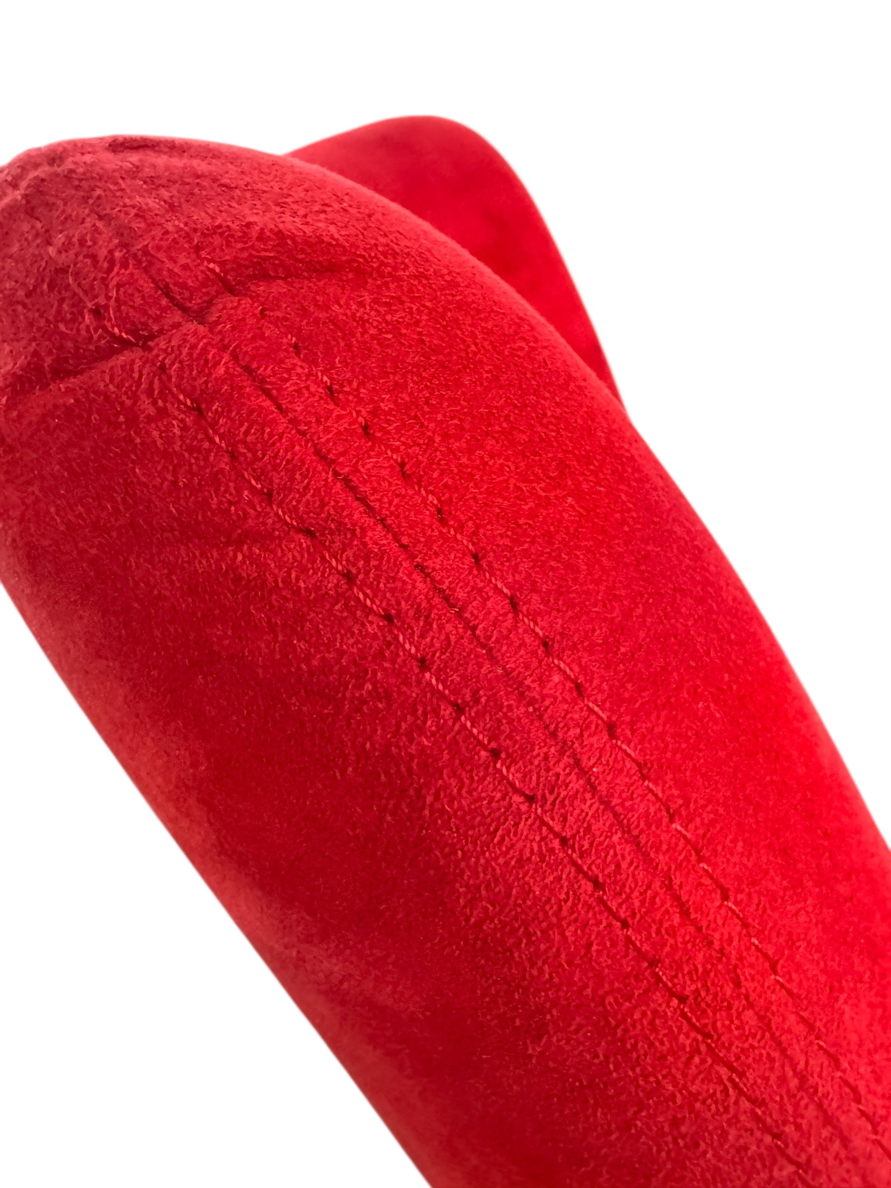 A Leolux Pallone armchair with a large, black, spherical leather seat and a smaller, red, curved leather backrest, supported by short metal legs.