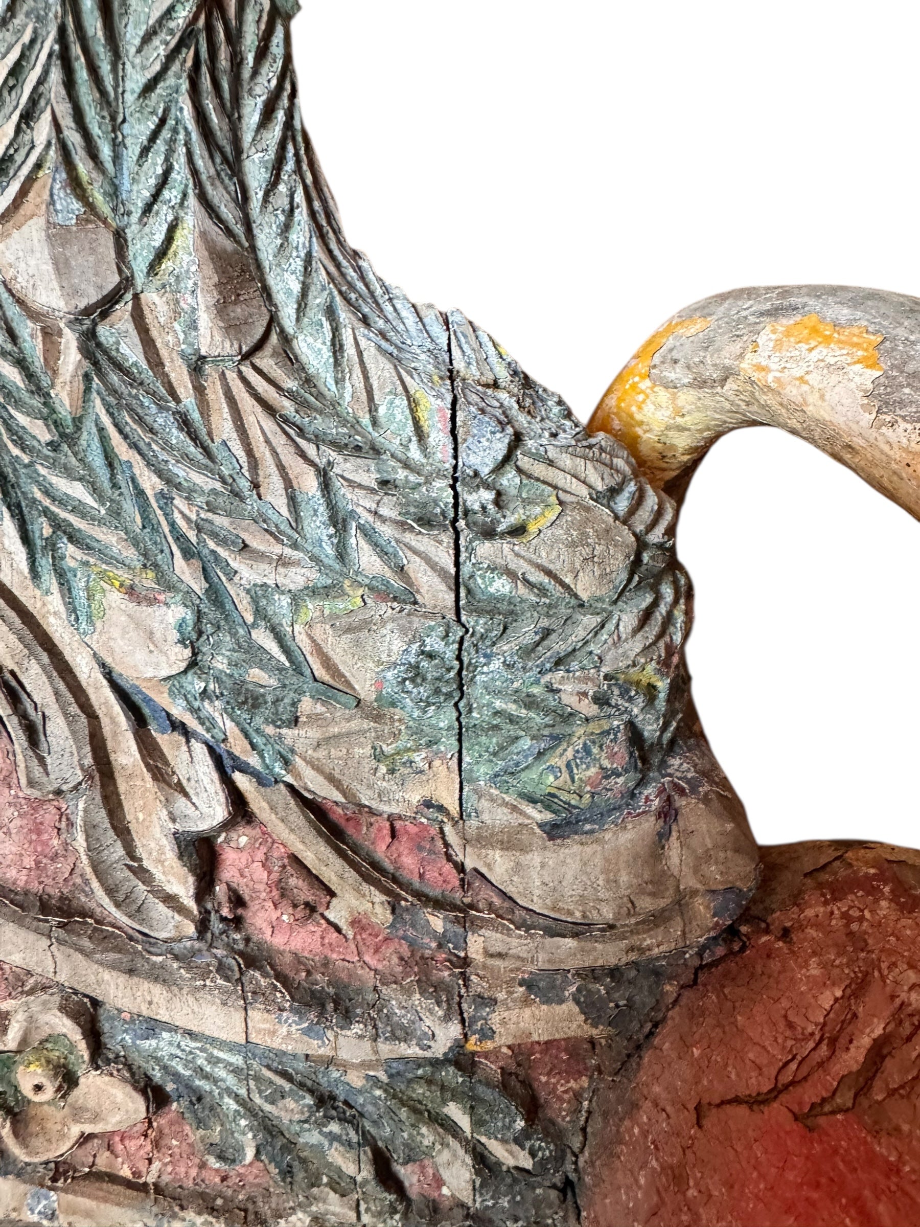 A pair of antique, heavily carved Anglo-Indian style throne chairs featuring lion figures as legs and arm supports, and peacock motifs on the backrests. The chairs have a distressed, multi-colored painted finish.