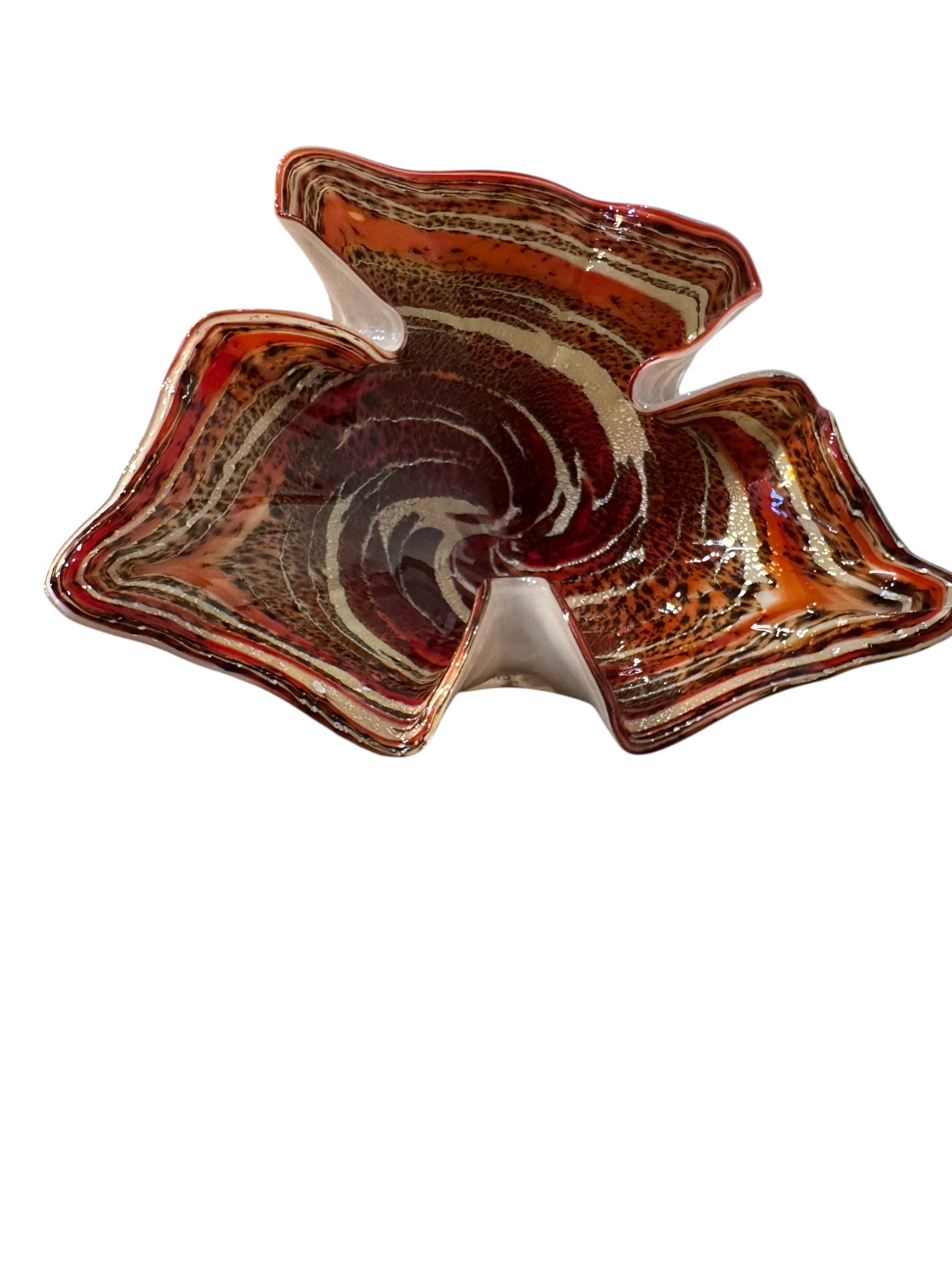 A Murano art glass bowl with a freeform shape, featuring layered swirls of brown, orange, and cream, accented with gold flecks. The bowl has a translucent white base.