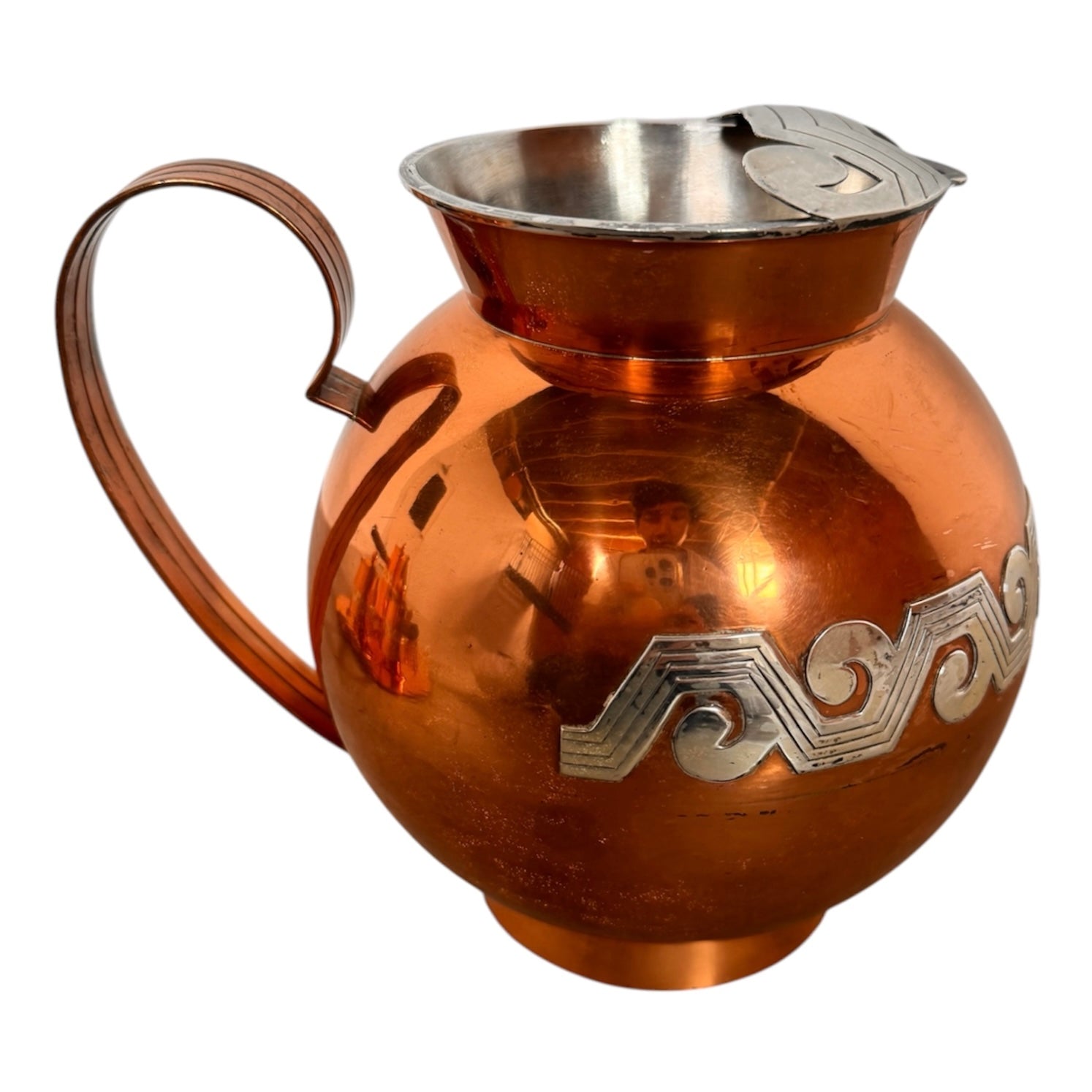The set includes a large, rectangular, hammered copper tray with geometric openwork handles. Resting on the tray is a tall, slightly tapered copper coffee pot with a wooden handle, a matching smaller creamer pitcher with a similar wooden handle, a lidded sugar bowl, and a tiny matching metal cup or jigger. To the right off the tray sits a large, spherical copper water pitcher or jug with a wide mouth and ice lip.