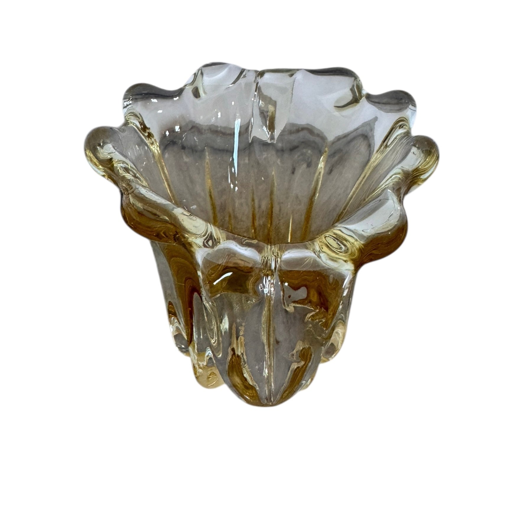 A hand-blown art glass vase with a scalloped, tulip-shaped rim, featuring an amber-to-clear color gradient and a ribbed base