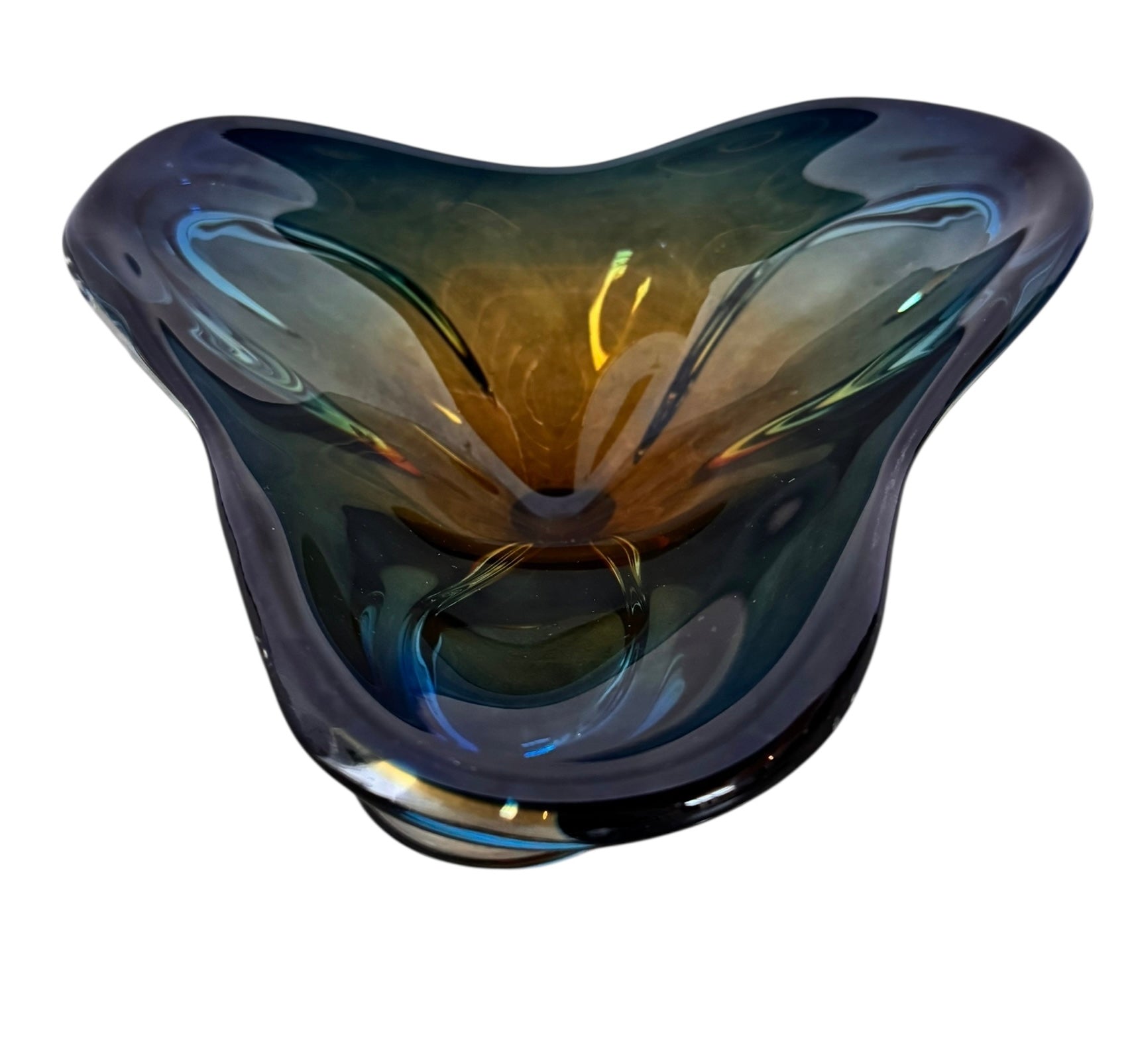 A vintage, hand-blown art glass bowl with a wavy, organic shape and a blue and amber/yellow swirl design