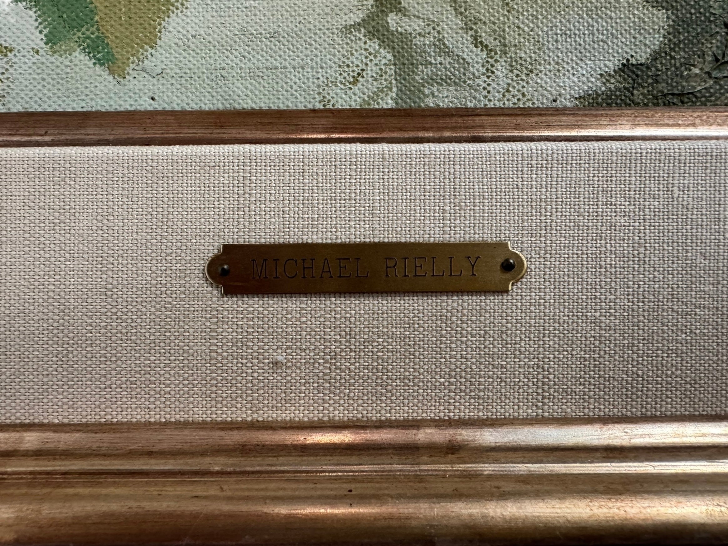 A naturalistic landscape oil painting by Michael Reilly titled "Mill Pond with Bridge" depicts a small town scene with a stone bridge over a mill pond, several buildings, and numerous bare trees under a grey sky