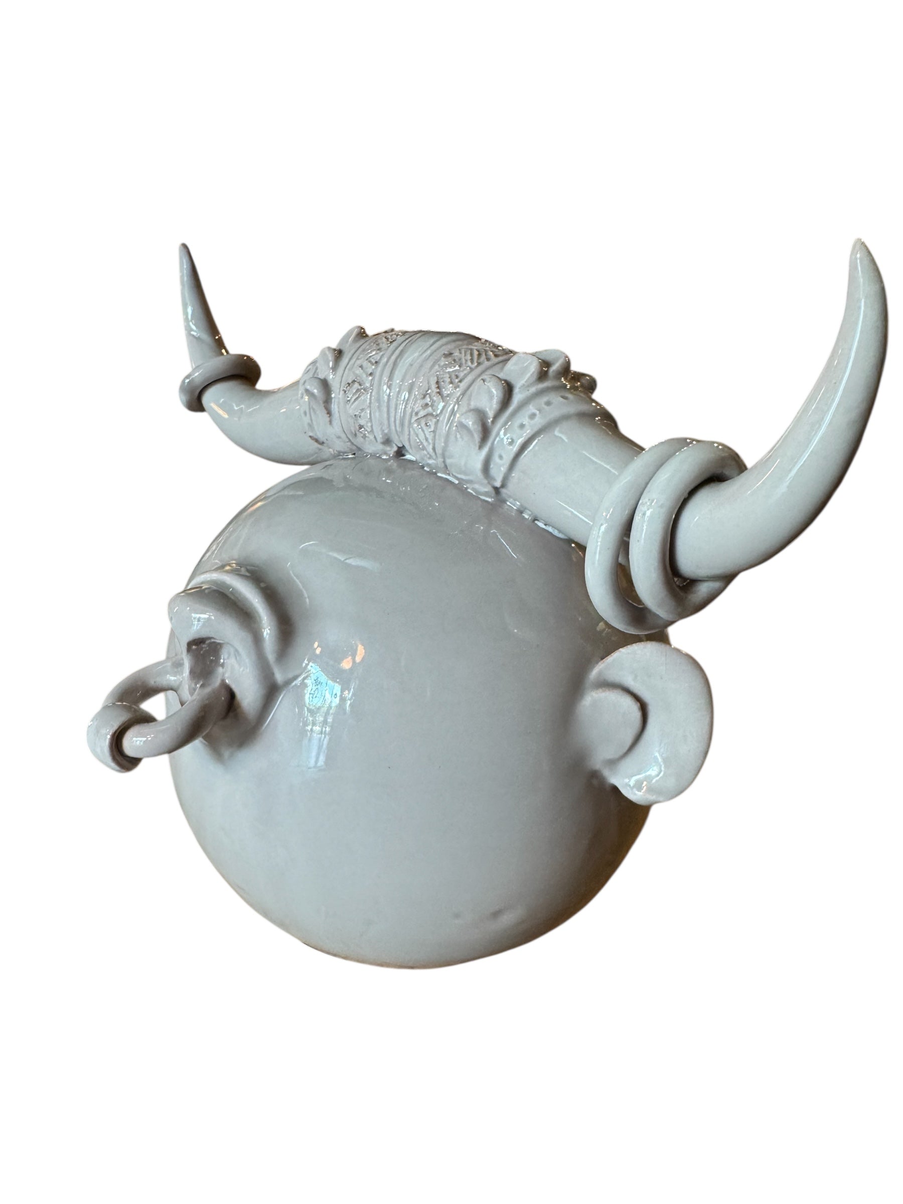 Artistic white grey ceramic bull sculpture by Enza Fasano, featuring a minimalist design and rings on the horns