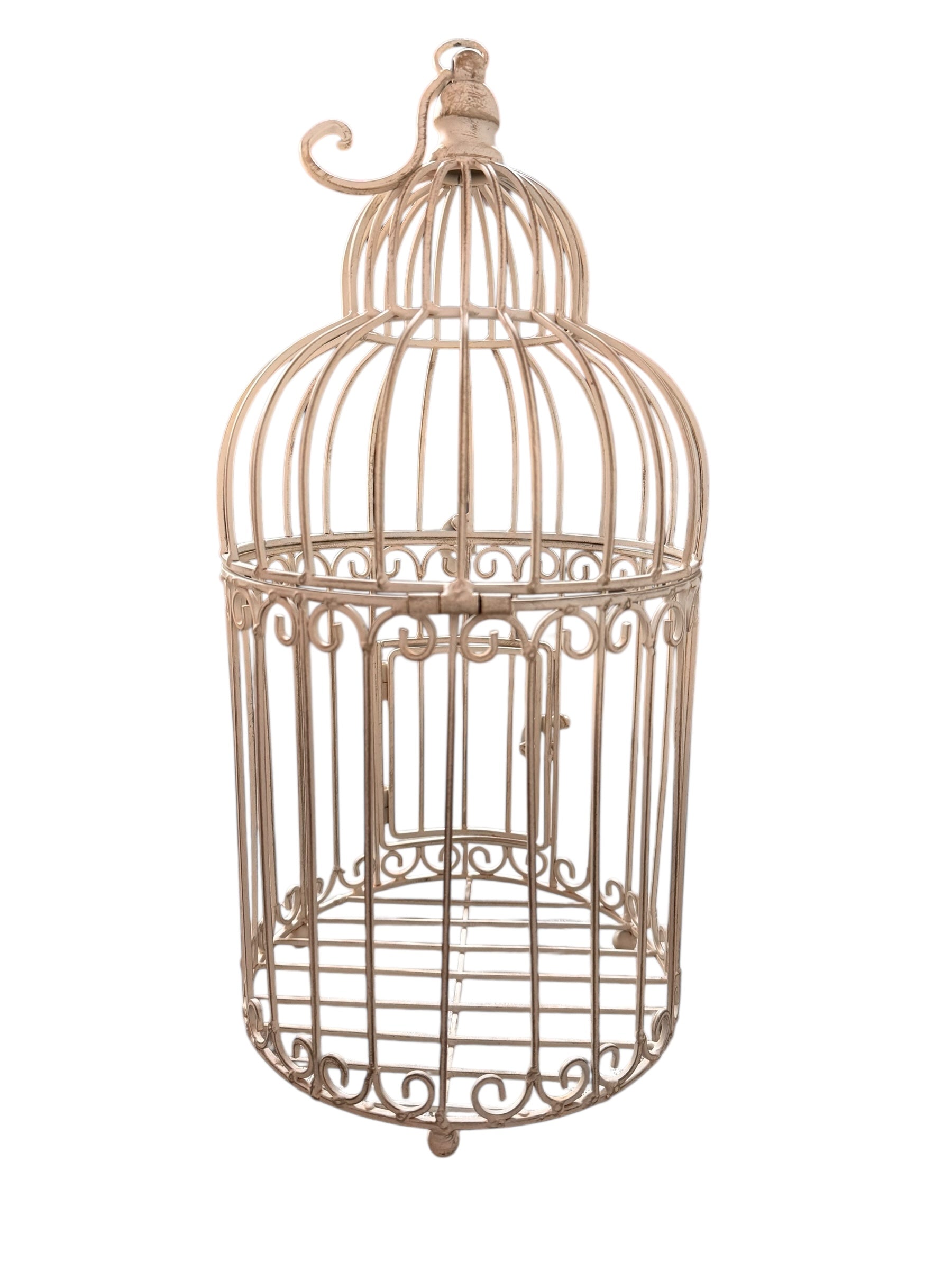A single, white or cream-colored, decorative wrought iron bird cage with a hinged door and a hanging loop at the top. The cage has a vintage or antique style