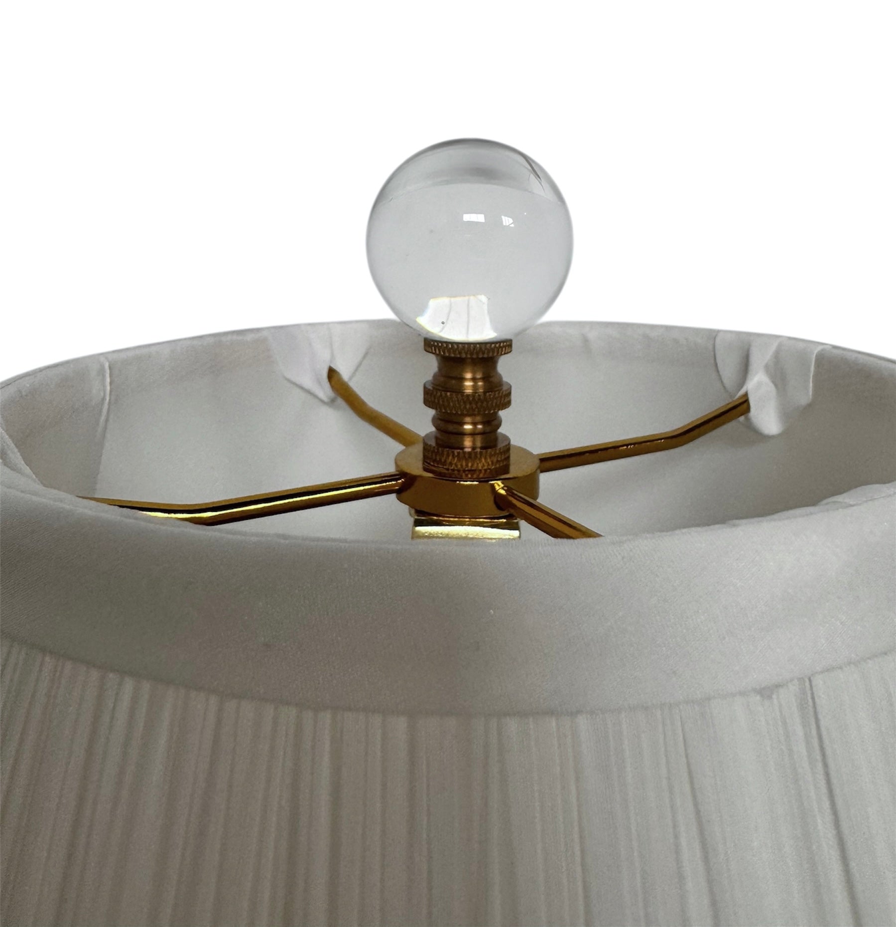 A tall, Mid-Century Modern sculptural table lamp featuring a hand-blown art glass base. The base is crafted in the Sommerso style, with a deep amethyst purple core encased in a thick, clear crystal outer layer that twists upward in an organic, fluid motion. The lamp is topped with a white, knife-pleated empire shade and a clear glass ball finial. The overall design is elegant and slender, emphasizing the contrast between the saturated purple glass and the transparent, light-refracting crystal.