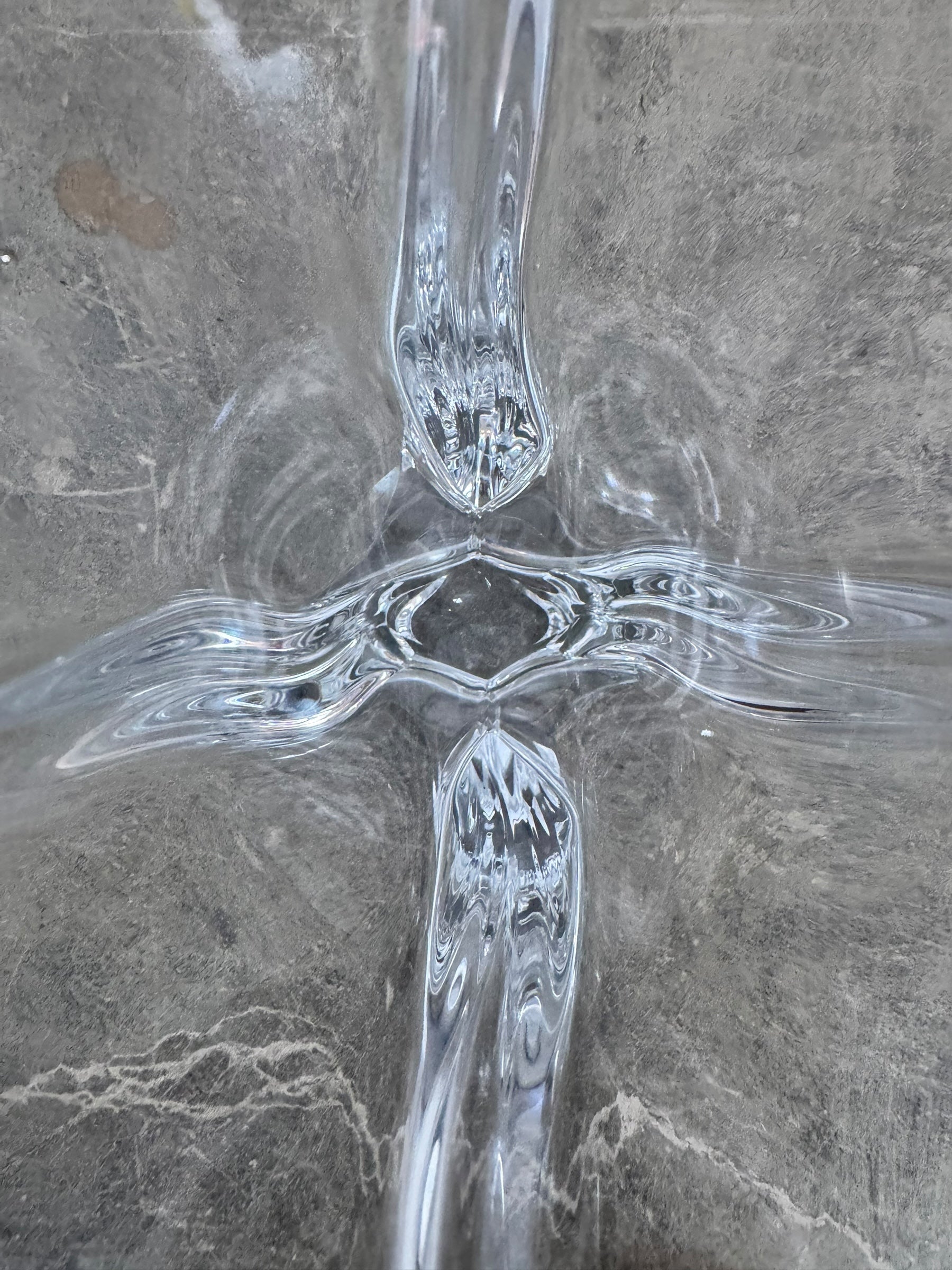 A clear crystal vase with a flared opening and a twisted, sculptural base.
The provided image is of a vintage Vannes Le Châtel crystal vase, which is a piece of French art glass