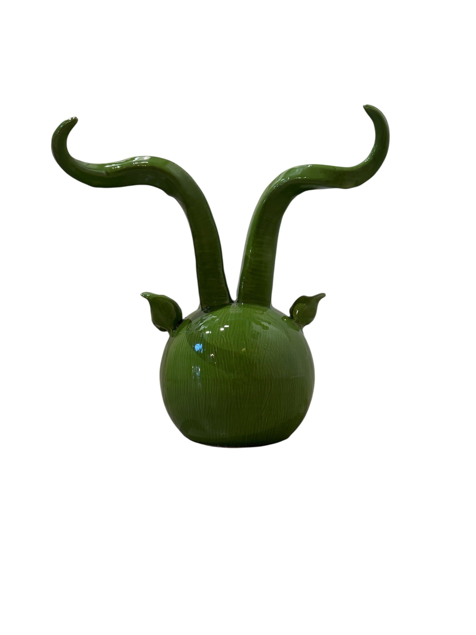 Glossy green ceramic pig sculpture with exaggerated, upward-curving horns and a snout.