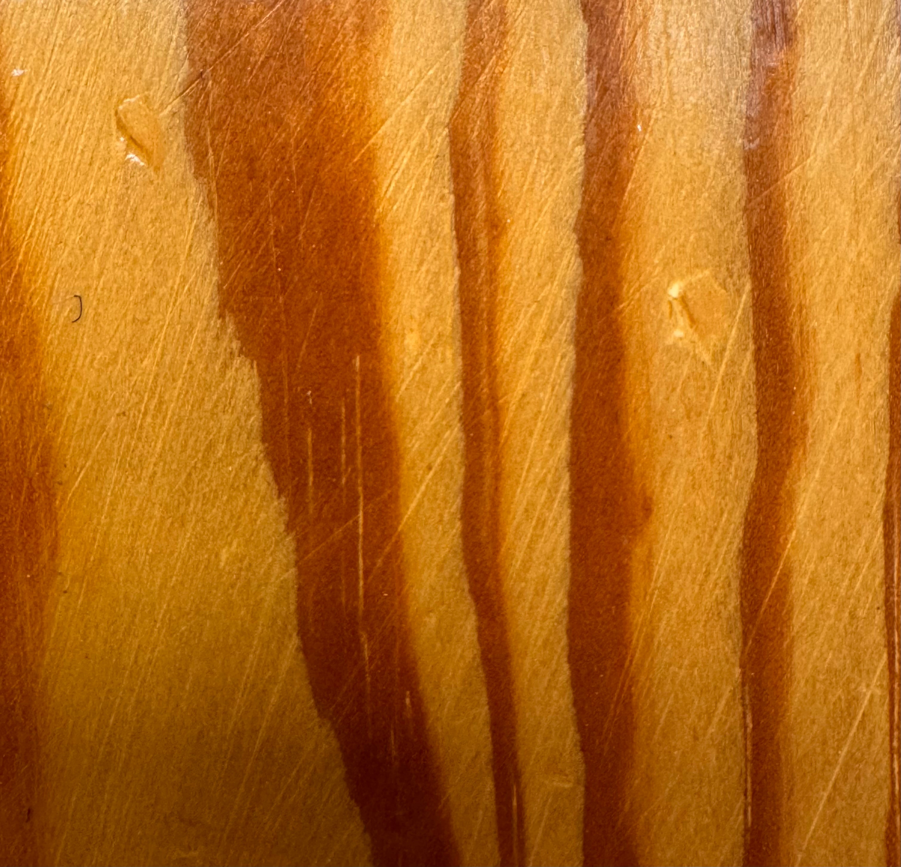 A wooden sculpture featuring a dark square base, a vertical trunk that branches into two angled supports, and a turned wooden sphere resting on the higher support.