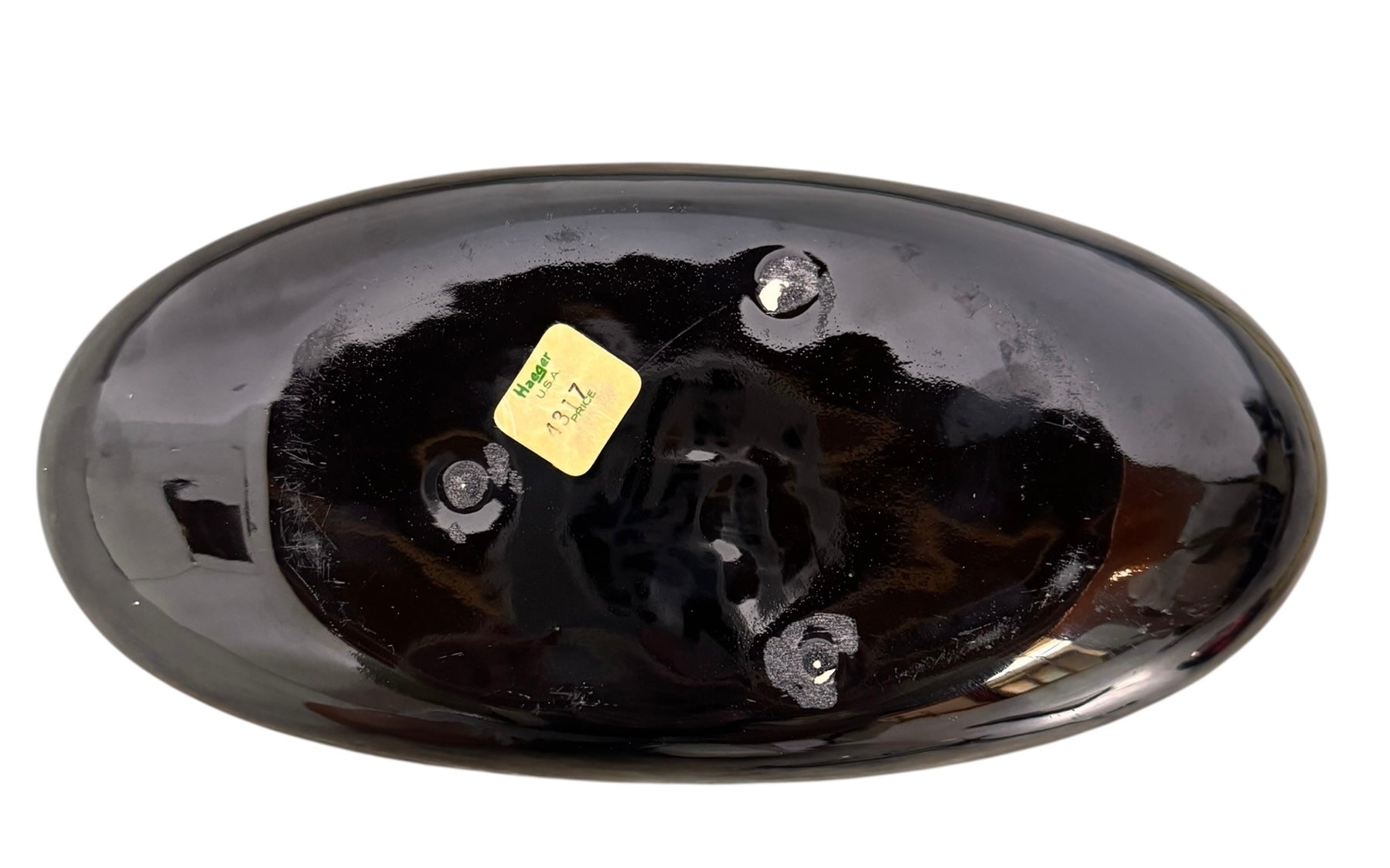 A round, glossy black vase with a small opening.
The vase has a spherical or gourd-like shape and a highly reflective, black glazed finish.