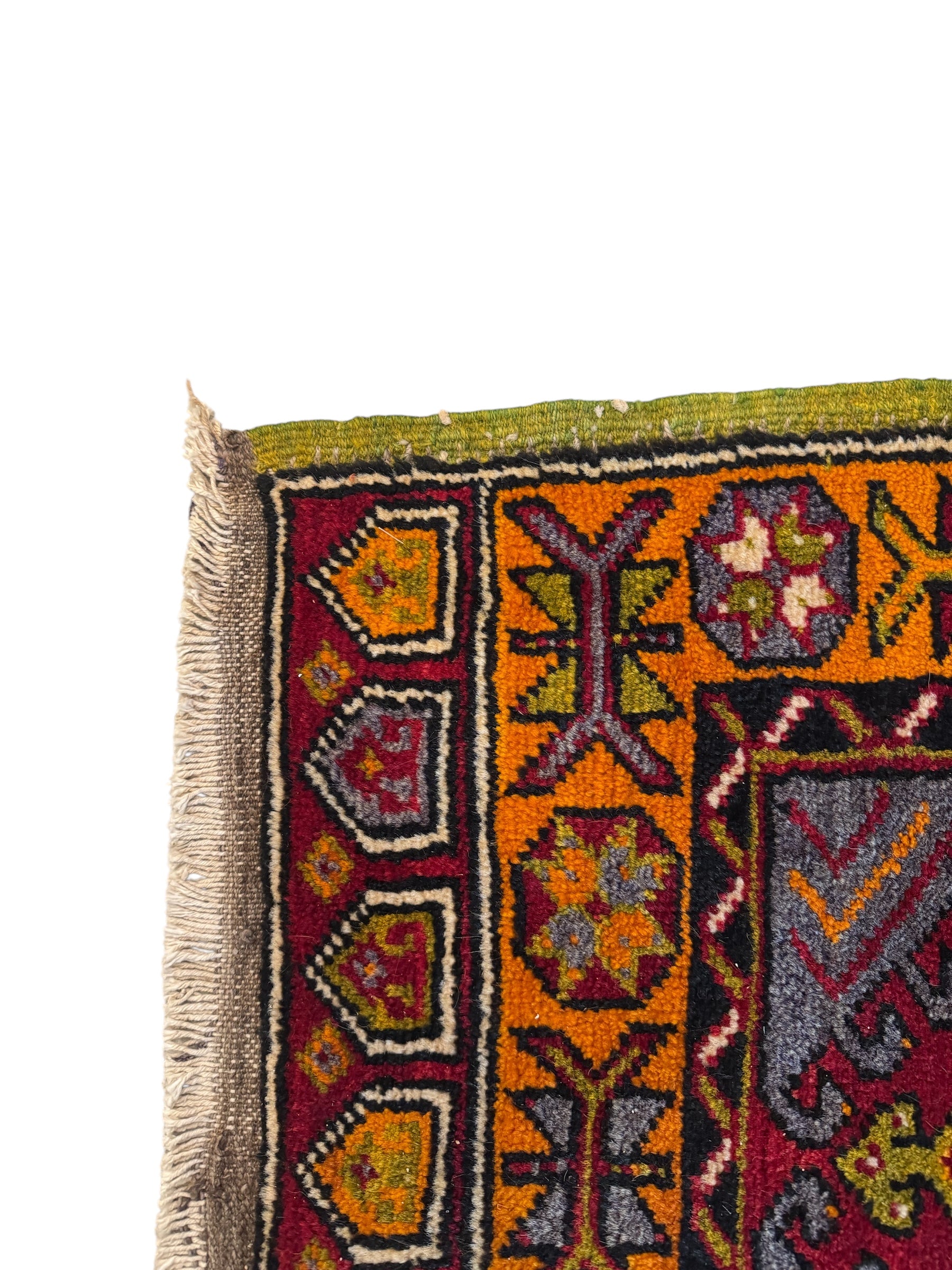Anatolian Yastik rug with red, gold, green and gray geometric patterns and fringe.