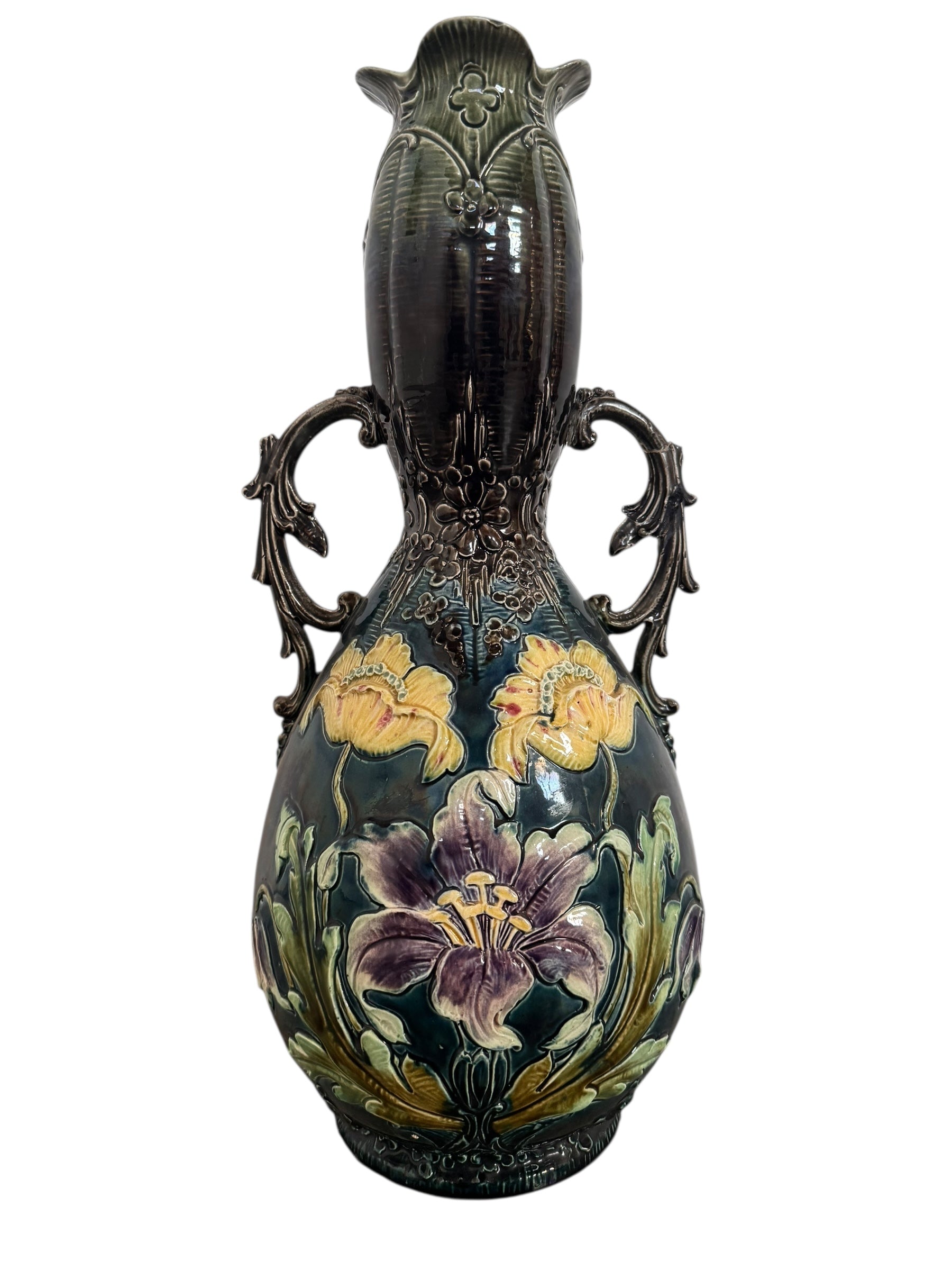 An ornate, dark glazed ceramic Art Nouveau vase with two handles and raised floral designs in yellow, purple, and green.