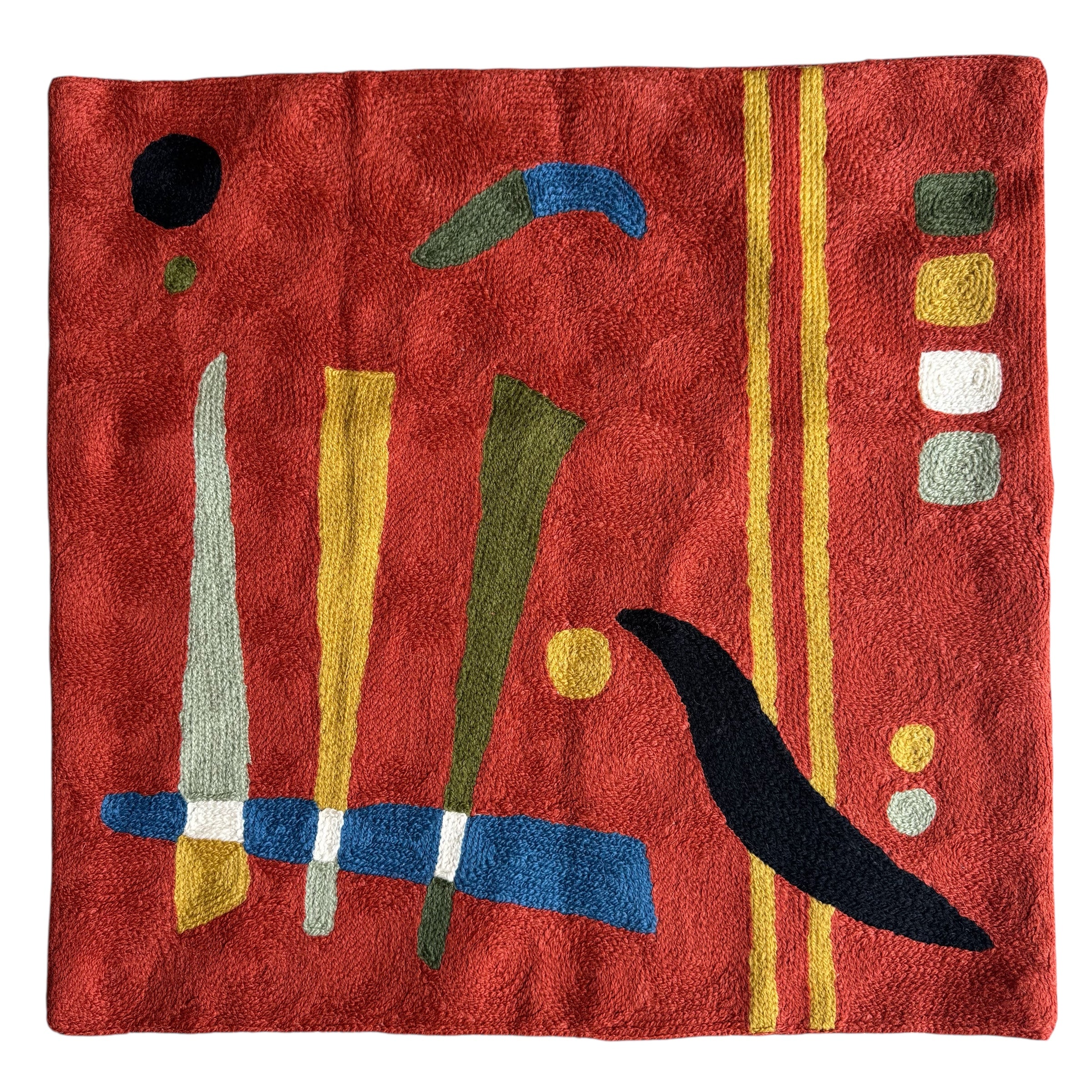 Abstract pattern. Orange background. Vibrant cross-stitched pillows from India with various artistic designs, sourced in Aix-en-Provence.