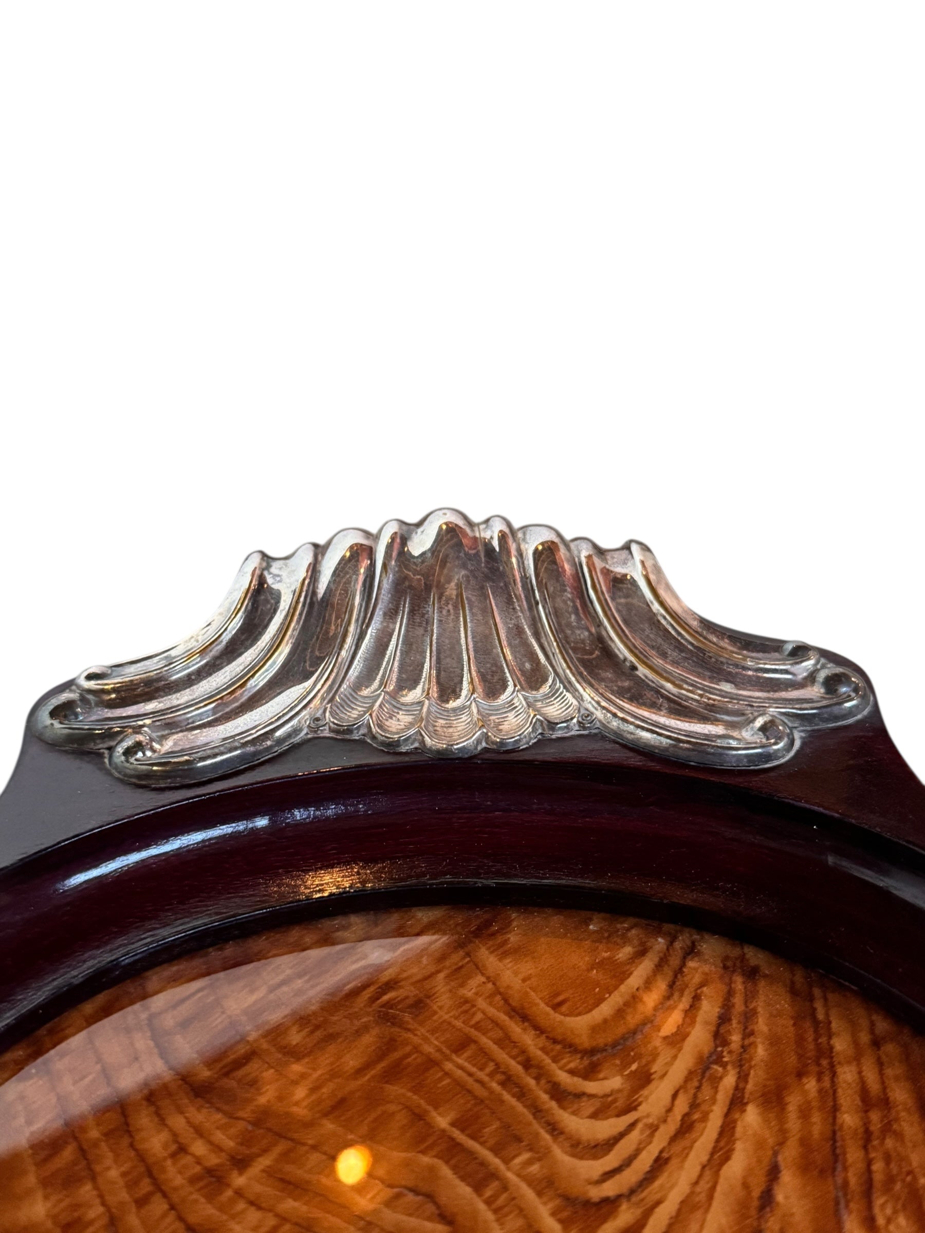 An ornate Art Deco serving tray featuring a highly figured burlwood center and silver-plated handles and rim