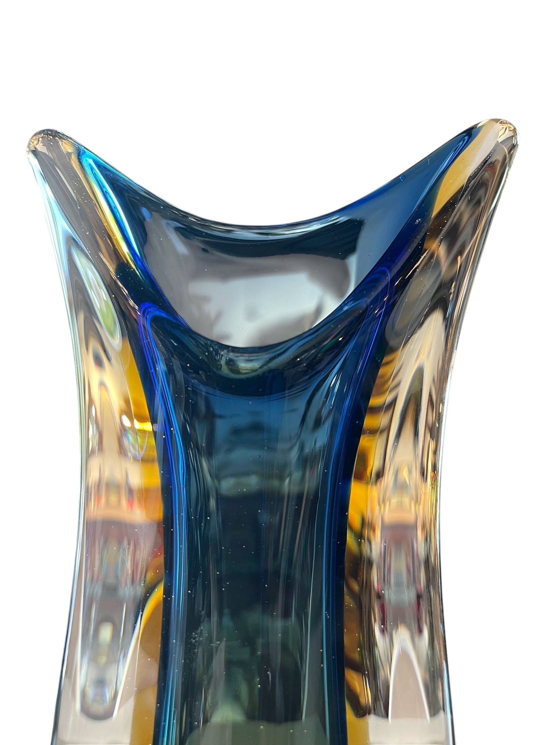 Sculptural art glass vase in the Sommerso style, featuring blue and amber colors encased in a clear glass layer. The vase has a vintage mid-century modern design